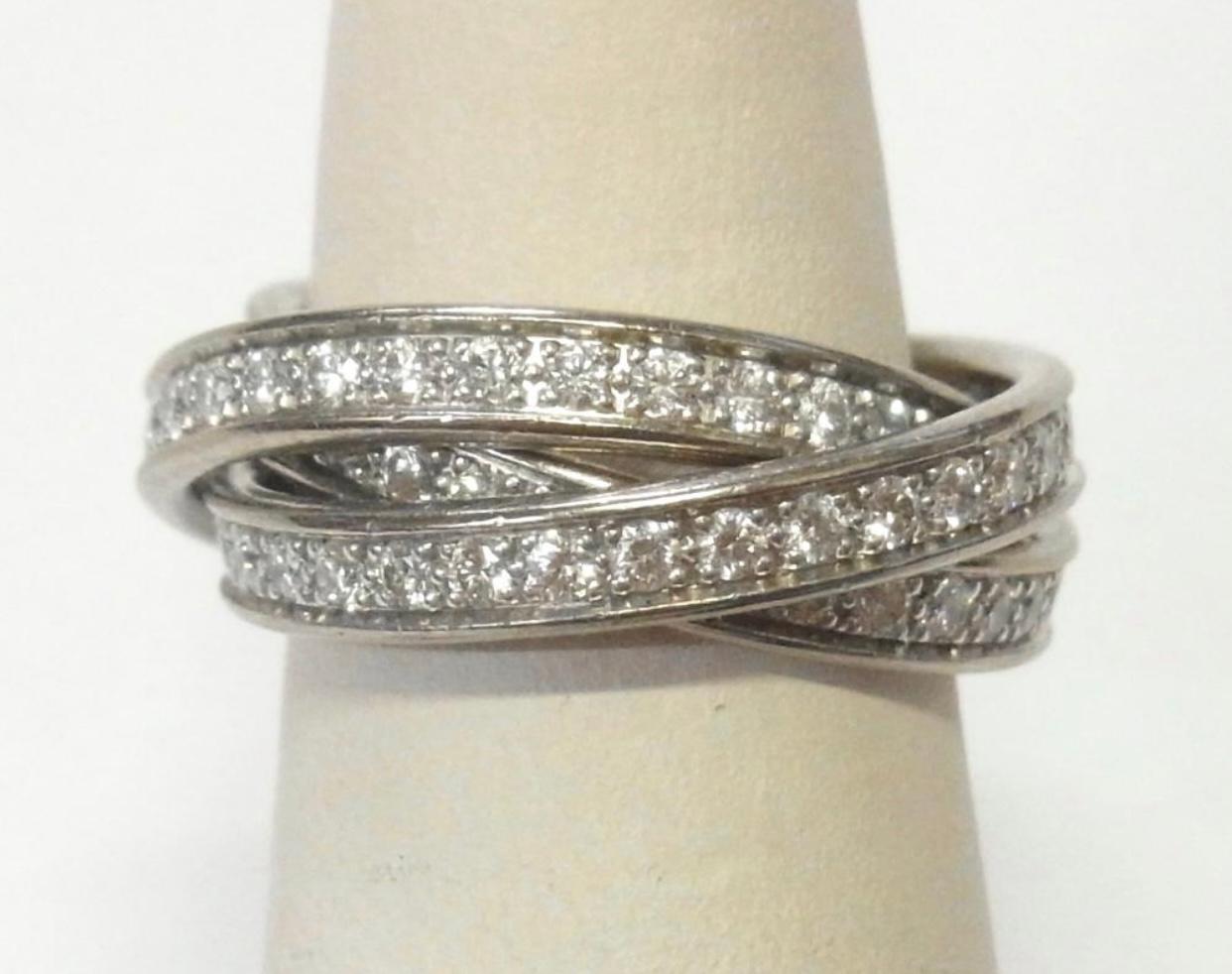 This gorgeous 1.67 ctw Cartier Diamond 18k White Gold Trinity Rolling Ring is in great condition and is perfect for your collection. Fine E-F Color, VVS2 to VVS1 clarity diamonds. It is signed and numbered with original boxes. Size 5 1/2. Circa