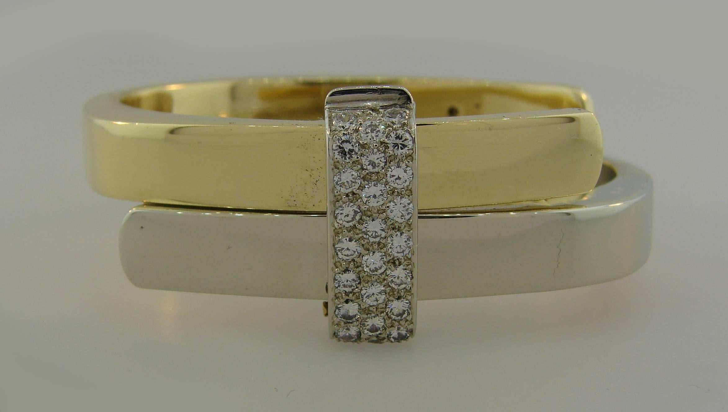 Bold and articulated bracelet created by Cartier in Italy in 1973. Chic and wearable, the bangle is a great addition to your jewelry collection. 
Made of 18 karat yellow and white gold and set with 1.24 carats of round brilliant cut diamonds (F-G