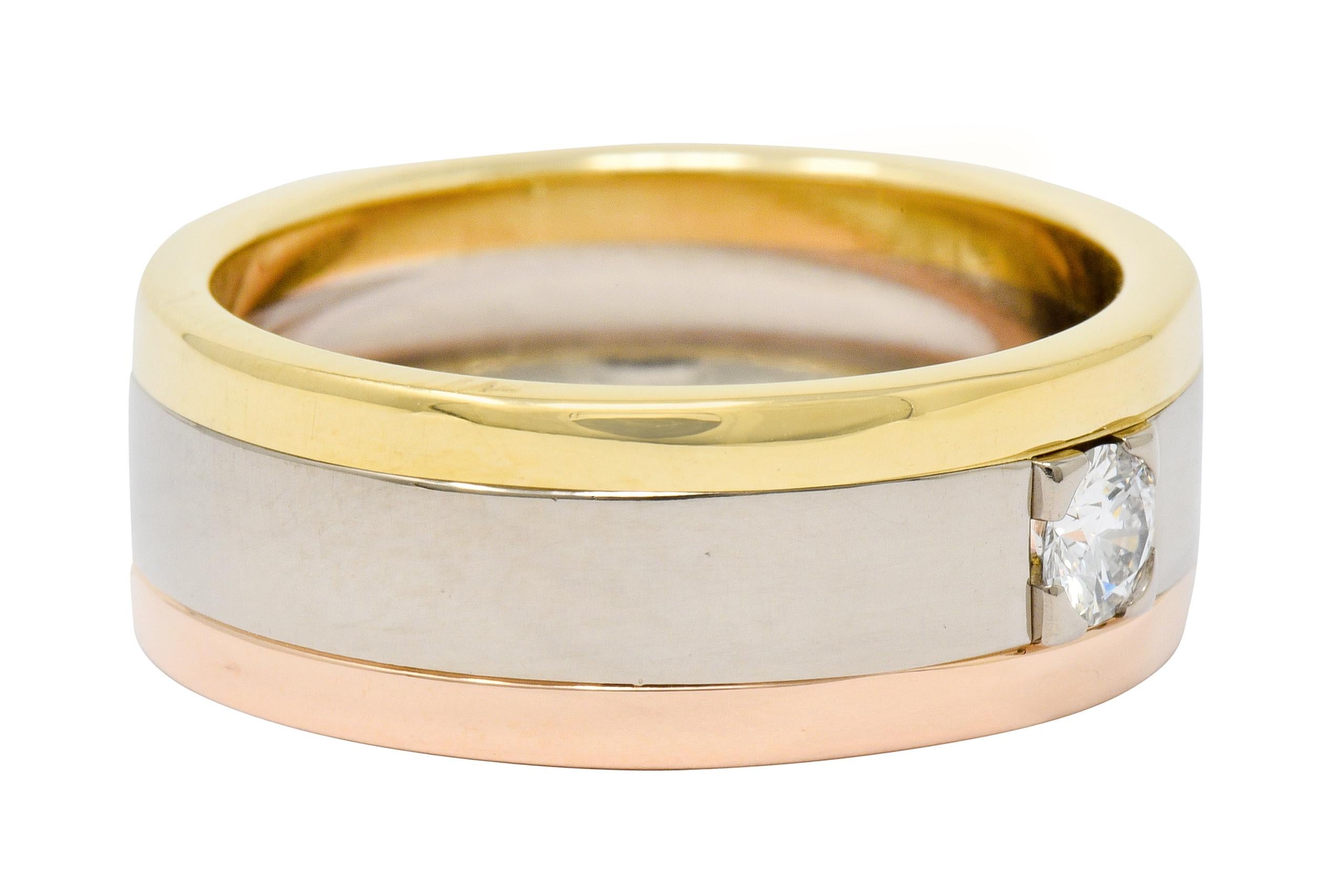 Wide band ring segmented three sections of white, yellow, and rose gold

Featuring a round brilliant cut diamond weighing approximately 0.20 carat, F/G color with VVS clarity

Set to front in a recessed square form head

From the prolific Trinity