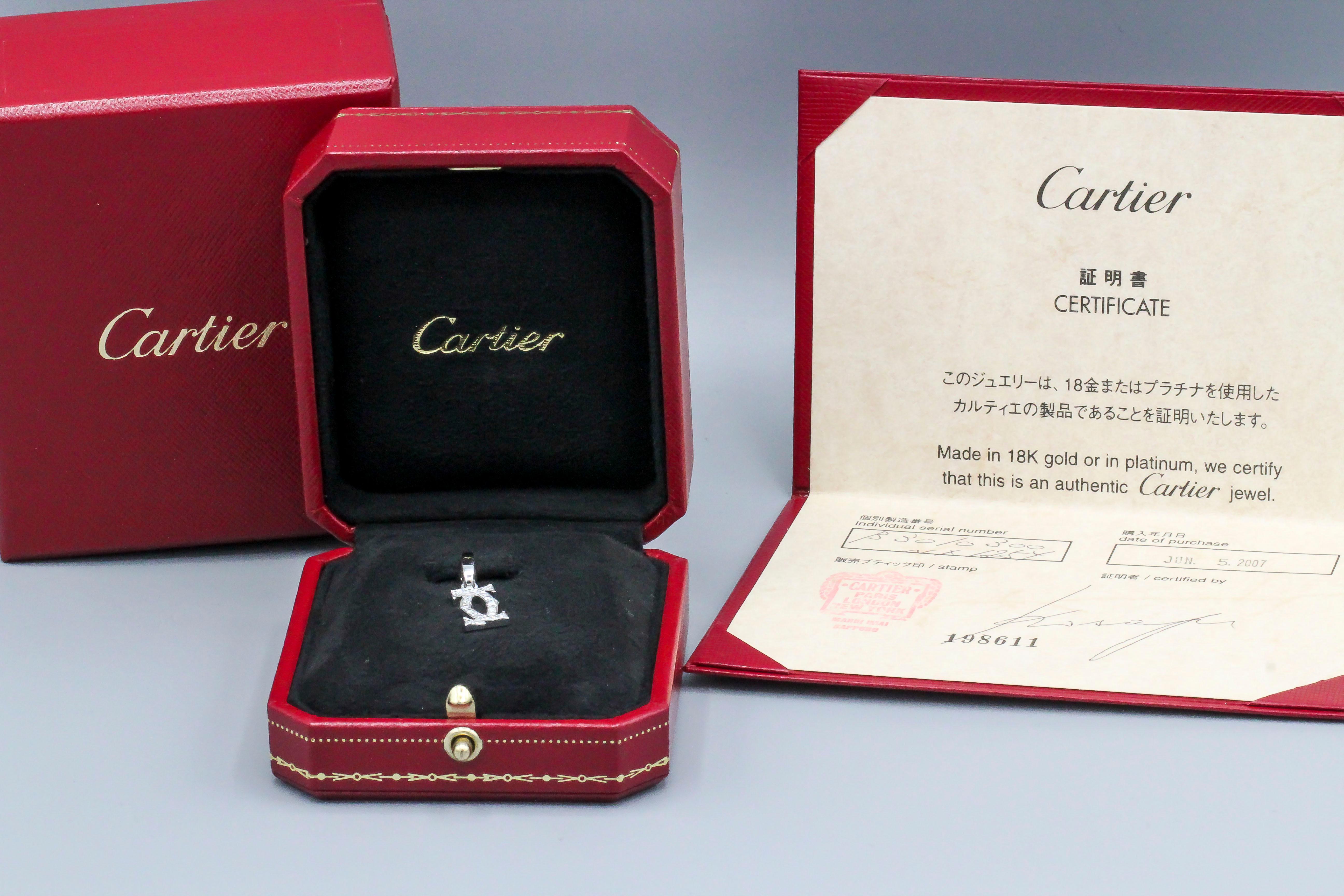 Fine diamond and 18K white gold charm by Cartier.  Designed as the interlocking double C Cartier logo, featuring high grade round brilliant cut diamonds.  Well made and easy to add to any bracelet or pendant.  With certificate of authenticity and