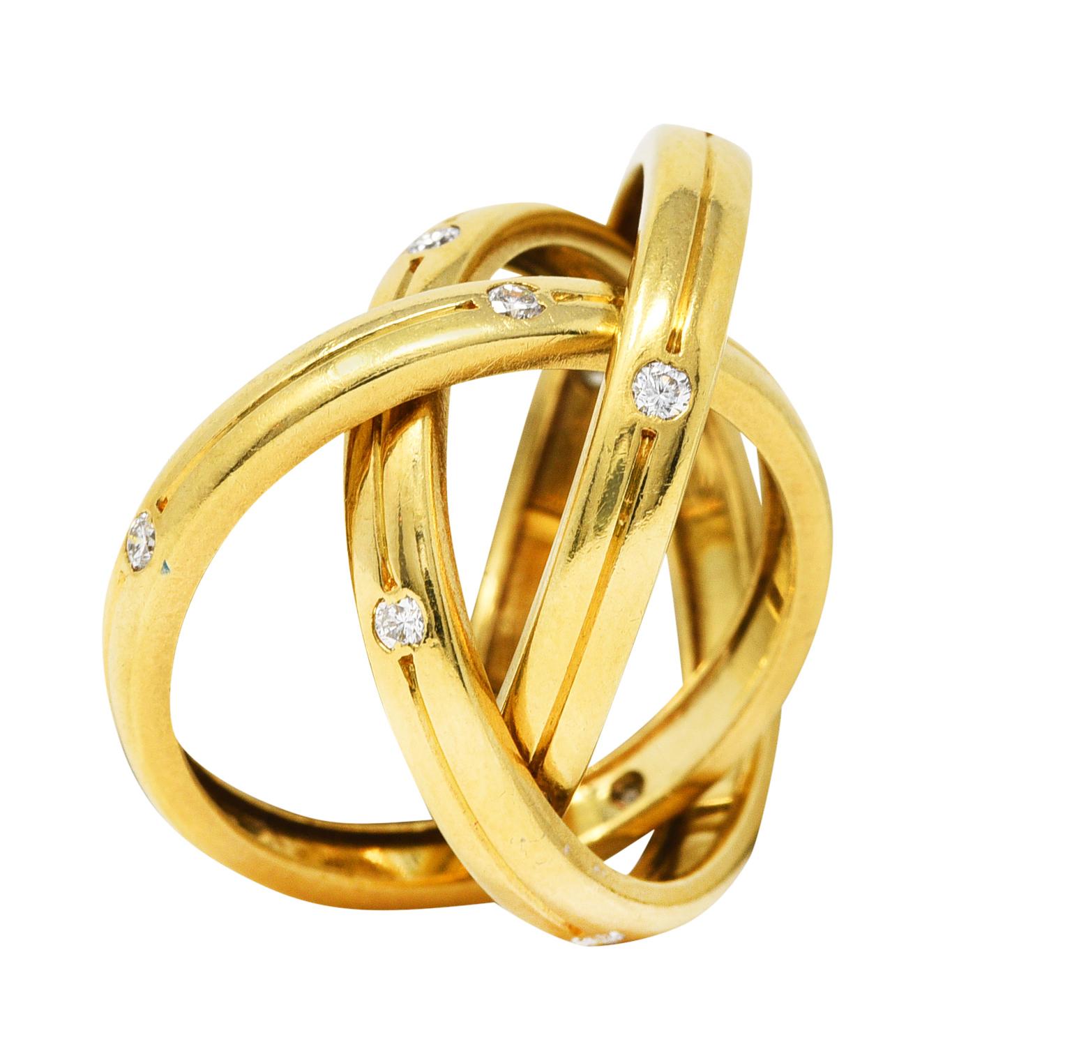 Designed as three grooved and intersecting gold band rings with a high polished finish

Accented by fifteen round brilliant cut diamonds weighing approximately 0.30 carat in total

Fully signed Cartier and stamped 18k for 18 karat gold

Ring Size: 4