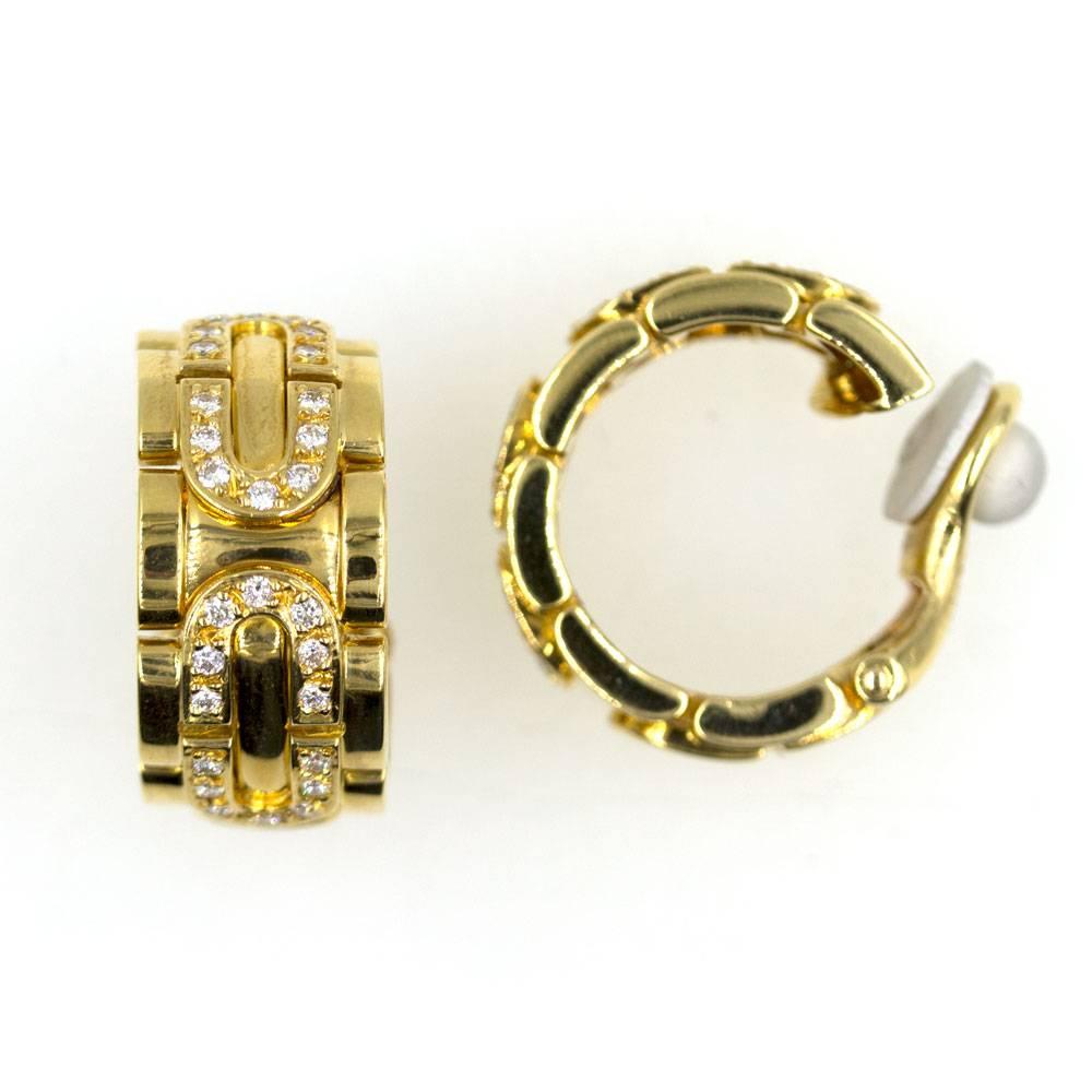 These beautiful Cartier clip earrings feature 1.12 carat total weight of diamonds set in 18 karat yellow gold. The earrings feature clip backs, measure 20mm in length, and 11.5mm in width. Signed Cartier 1996 and numbered. 