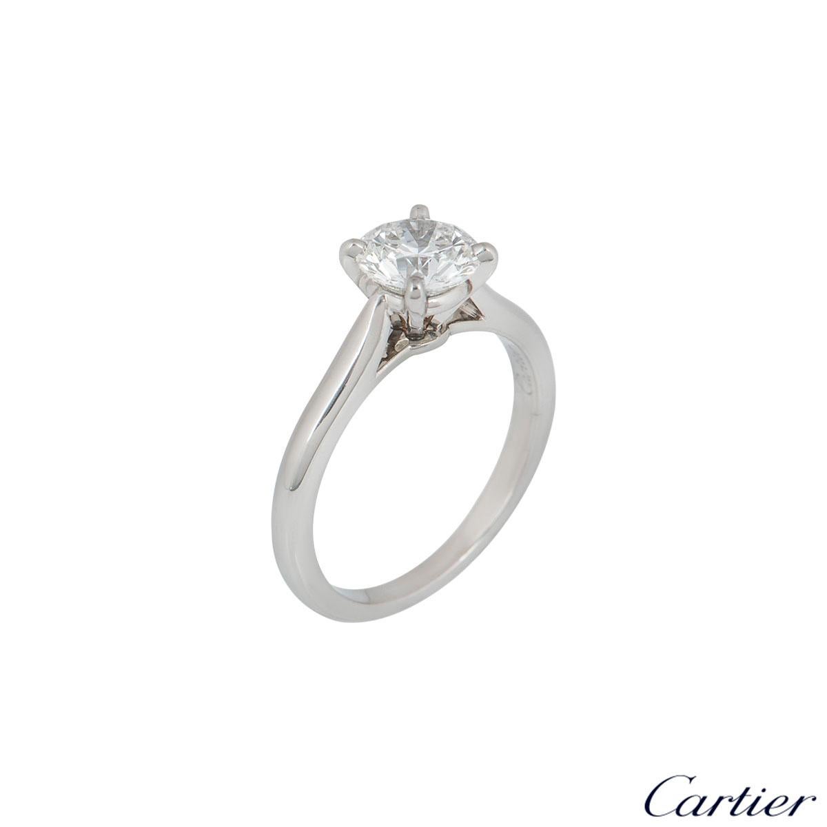 A stunning platinum diamond engagement ring by Cartier from the 1895 solitaire collection. The ring comprises of a round brilliant cut diamond in a four claw setting with a weight of 0.90ct, H colour and VS1 clarity. The diamond scores an excellent