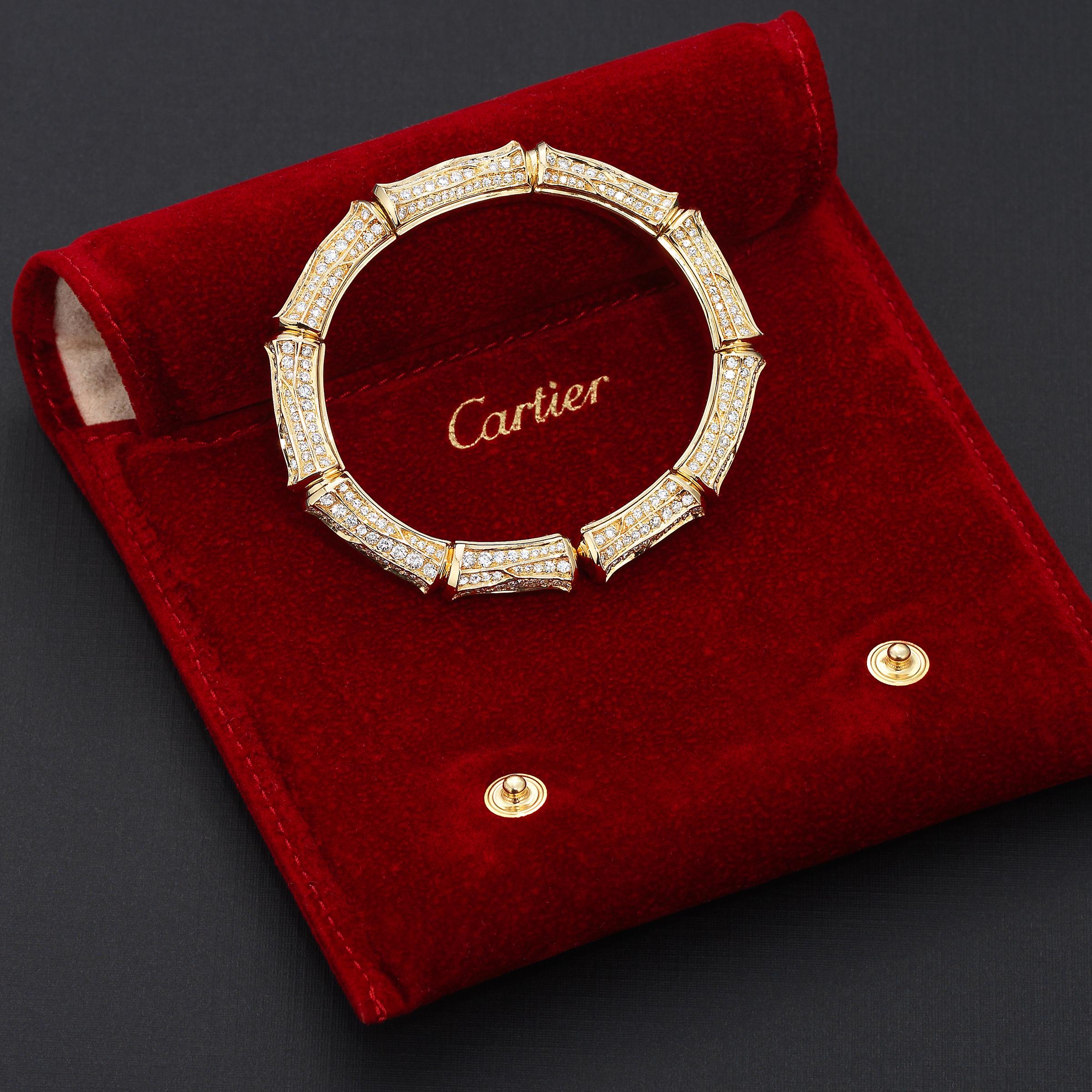 Dazzling vintage Cartier Bamboo cuff bracelet showcasing approximately 10 carats of fine-white brilliant round diamonds impeccably set in lustrous 18 karat yellow gold. The cuff bracelet is wonderfully flexible and encircles the wrist effortlessly