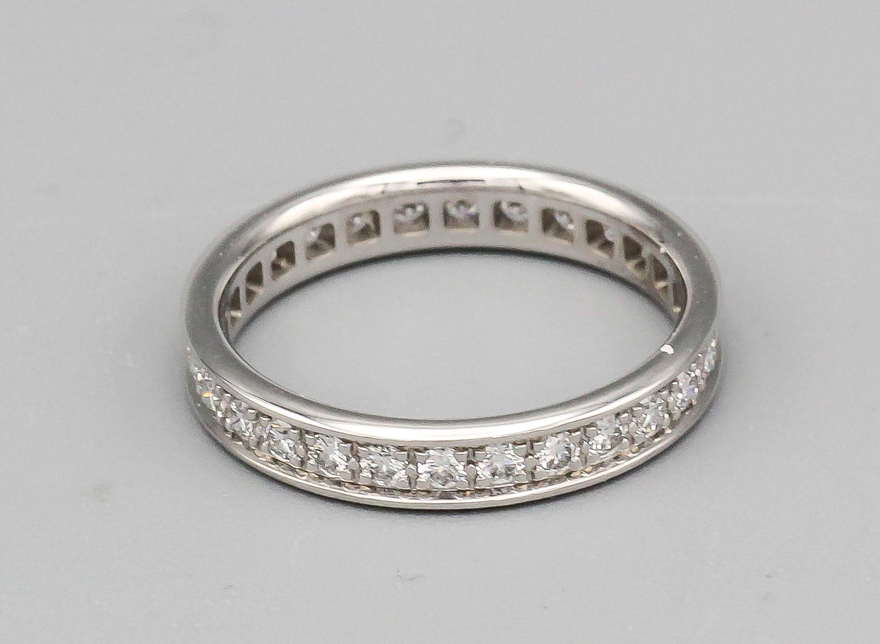 Fine diamond and 18k white gold band by Cartier. It features high grade round brilliant cut diamonds and is 3.3 mm wide. Approx. size 5 (European size 49)

Hallmarks: Cartier, 750, 49, reference numbers, maker's mark.