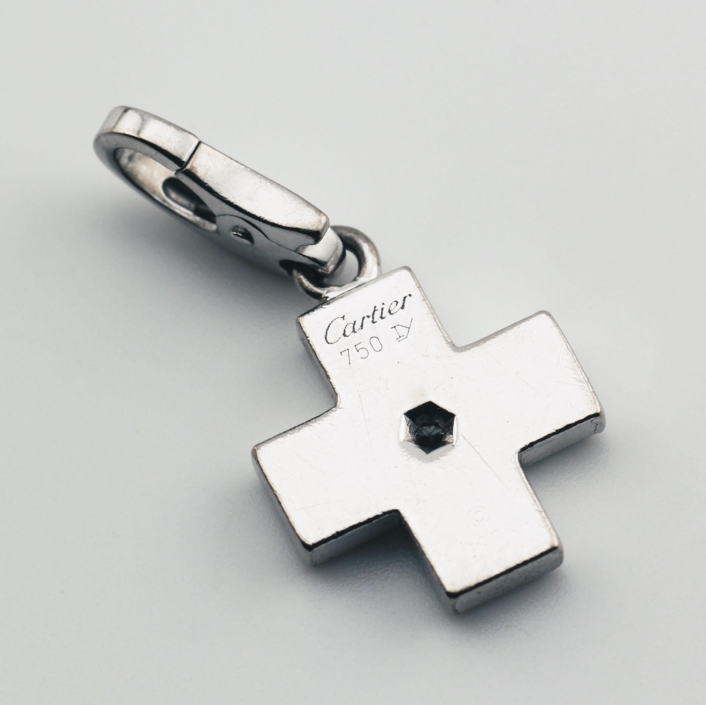 The Cartier Diamond 18K White Gold Cross Charm Pendant is a refined and elegant piece that exemplifies Cartier’s timeless design aesthetic. Crafted in polished 18K white gold, the pendant features a sleek and minimalist cross, symbolizing grace and