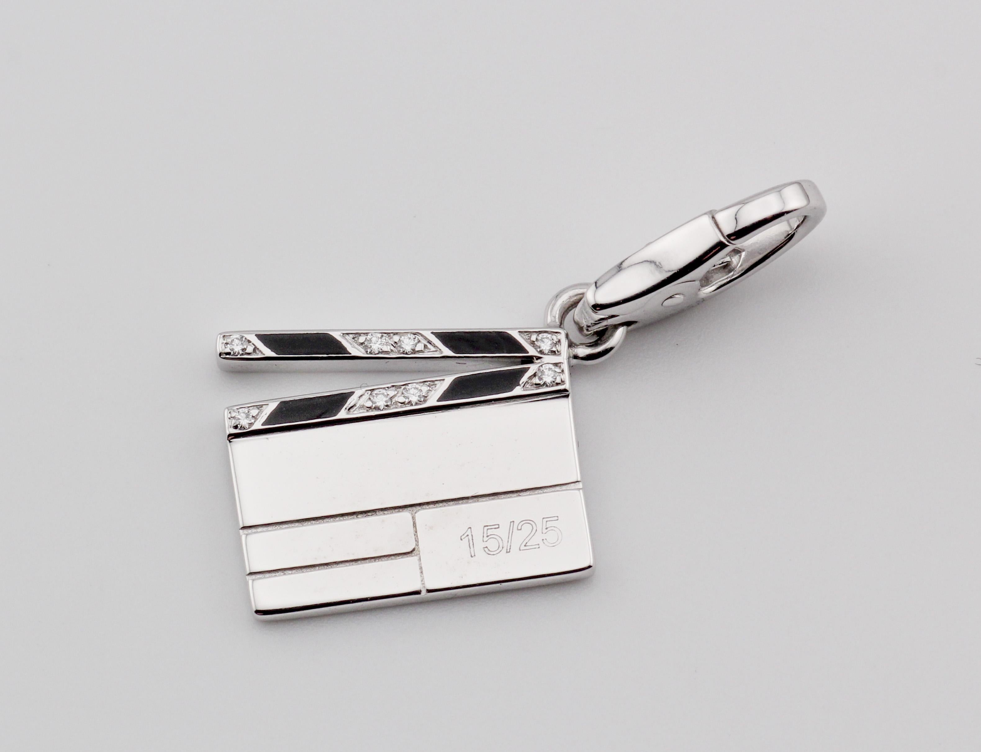 Indulge in the epitome of luxury and cinematic charm with the Cartier Diamond 18K White Gold Enamel Limited Edition Clapperboard Charm Pendant. Crafted by the iconic French jeweler Cartier, this pendant is a masterpiece that harmonizes exquisite