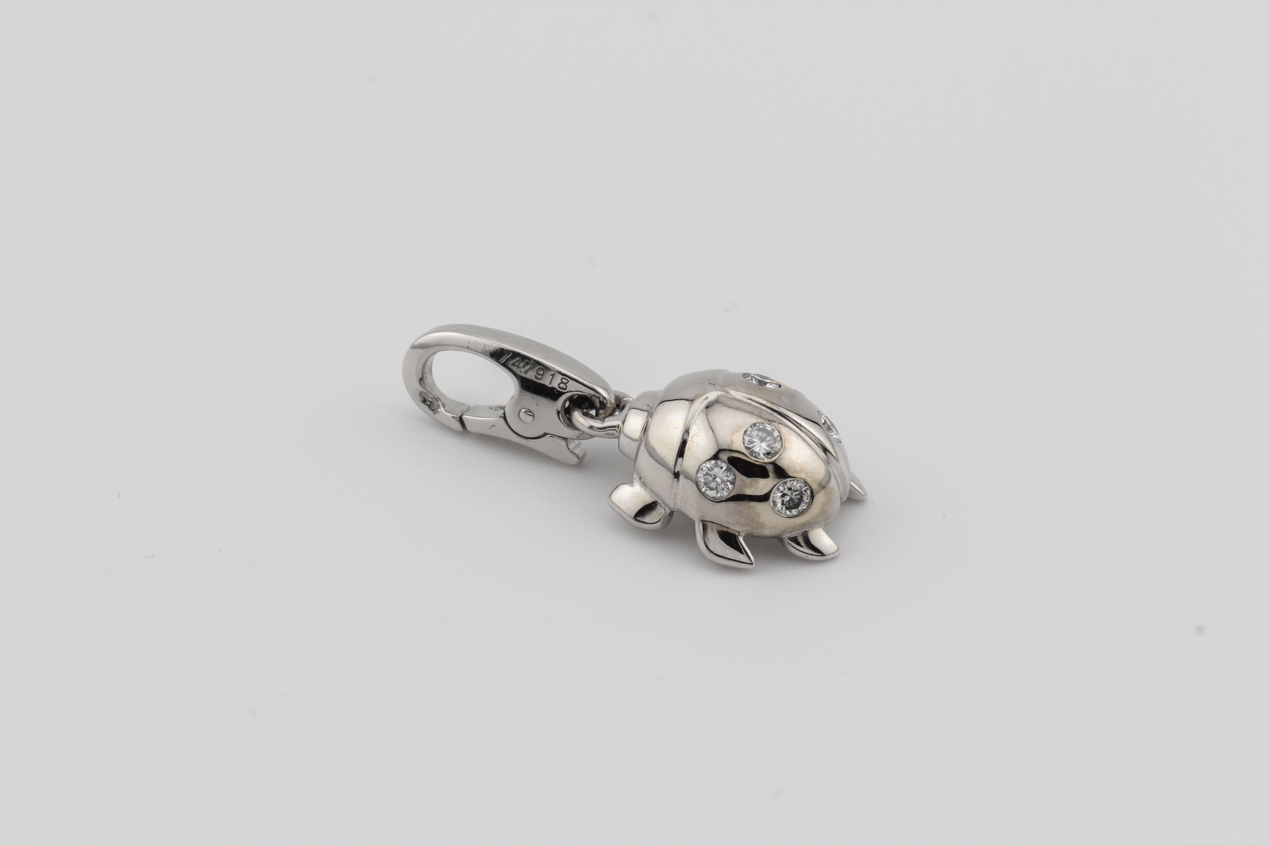 Embrace the enchanting allure of this Cartier Diamond 18k White Gold Ladybug Charm Pendant, circa 2000. Meticulously crafted, this pendant is a testament to Cartier's legacy of creating exceptional jewelry that seamlessly blends whimsy with