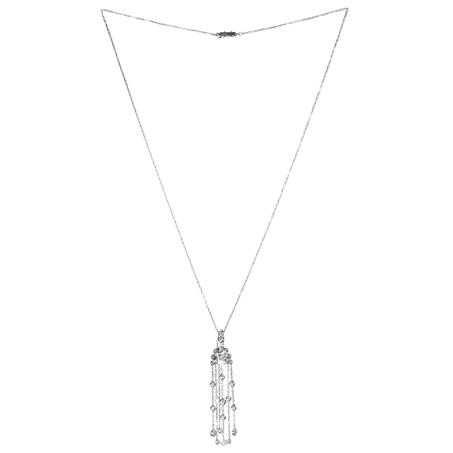 This exquisite Cartier long chain necklace is crafted in 18k white gold and features tassel pendant bezel-set with 30 D-E-F VVS1-VVS2 brilliant cut-round diamonds. Made in France circa 2011. Measurements: 0.55