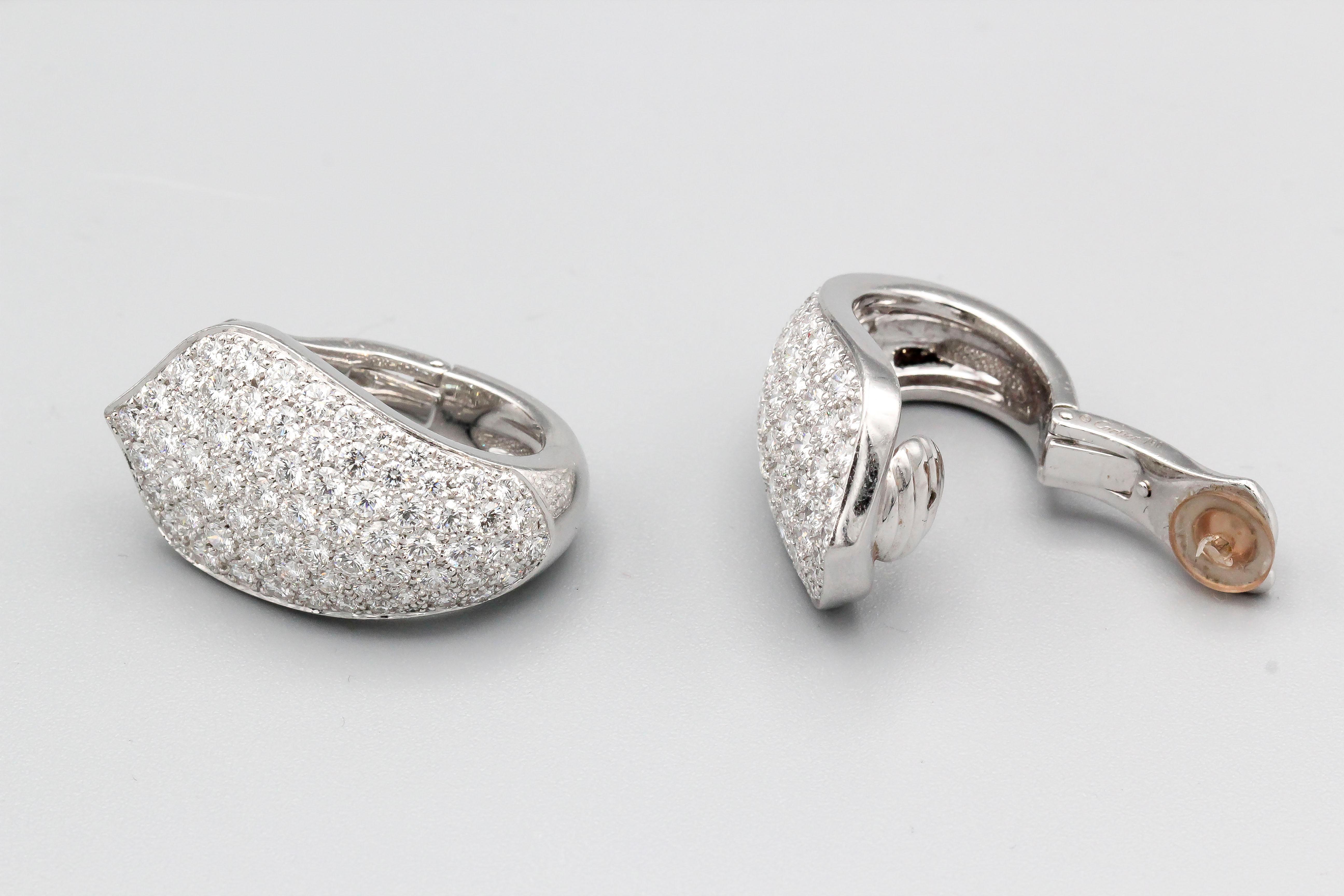 Elegant diamond and 18K white gold hoop earrings by Cartier. They feature high grade round brilliant cut diamonds, approx. 10 cts total weight.

Hallmarks: cartier, 750, copyright, reference numbers, French 18K gold assay mark, maker's mark.