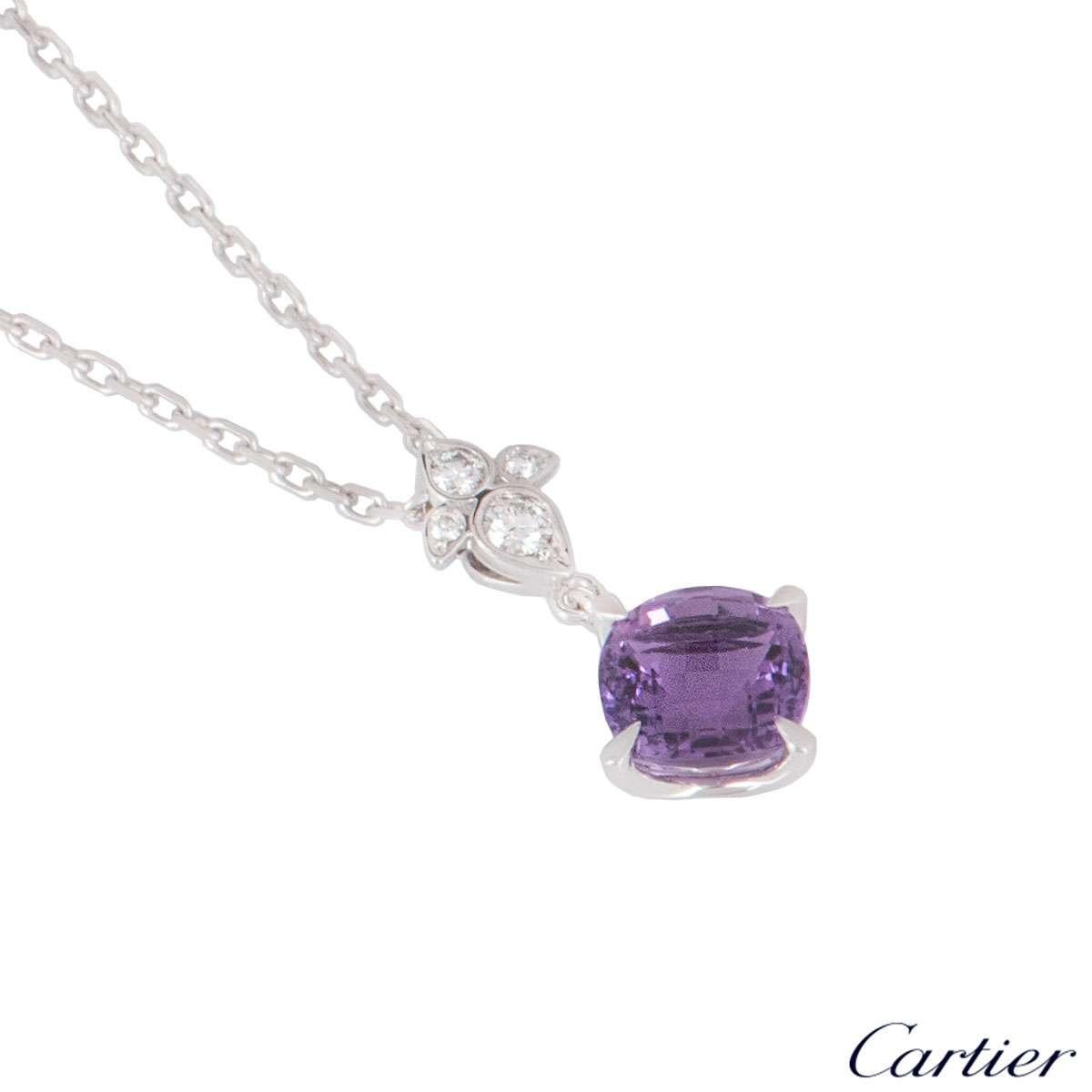 An 18k white gold amethyst and diamond pendant from the Lotus collection by Cartier. The pendant features a faceted cushion cut amethyst suspended from a diamond set lotus motif. The amethyst has a total weight of approximately 2.20ct and the