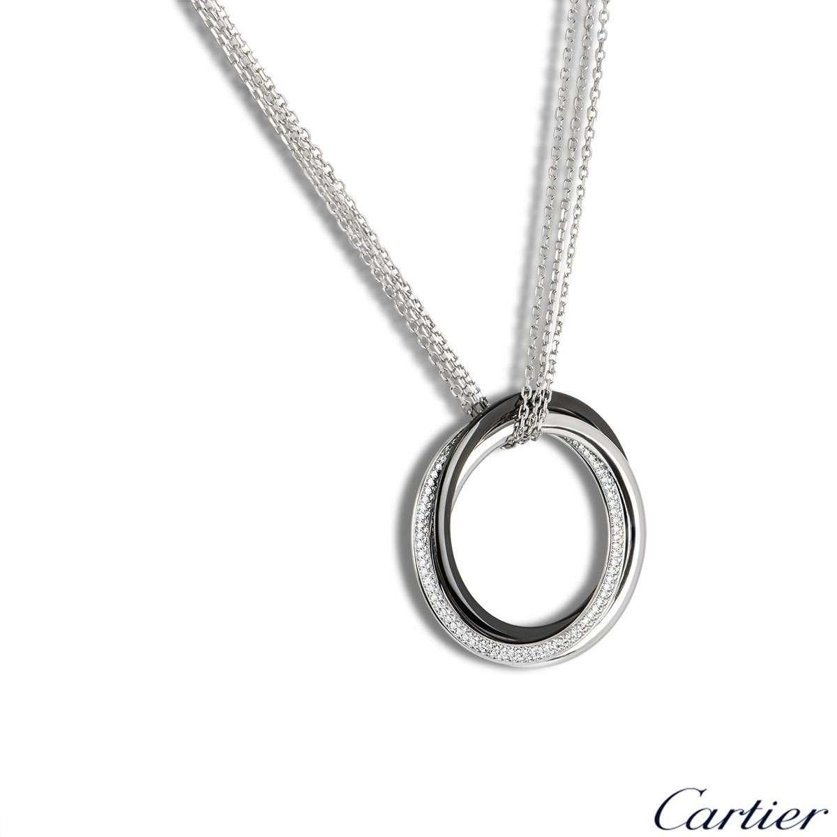 A stylish 18k white gold Cartier diamond and ceramic necklace from the Trinity de Cartier collection. The pendant features triple interlaced rings, two in white gold and one black ceramic, one white gold ring has 166 round brilliant cut diamonds