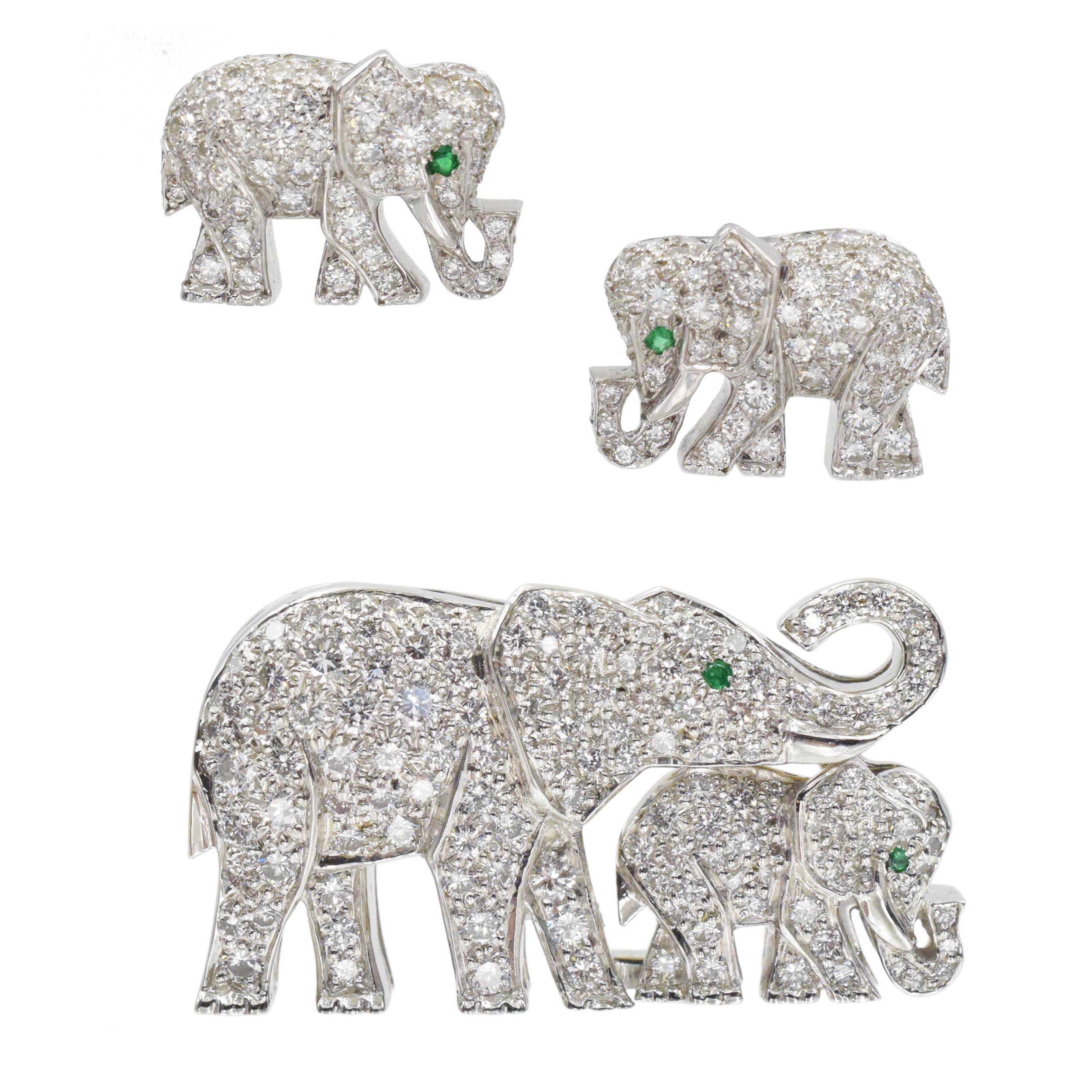 Cartier Diamond and Emerald Elephant Brooch and Earrings Set In Platinum.
 The Brooch feature mother elephant with a calf walking in front of her encrusted with 136 round brilliant cut diamonds with total weight of approximately 1.75ct and accented