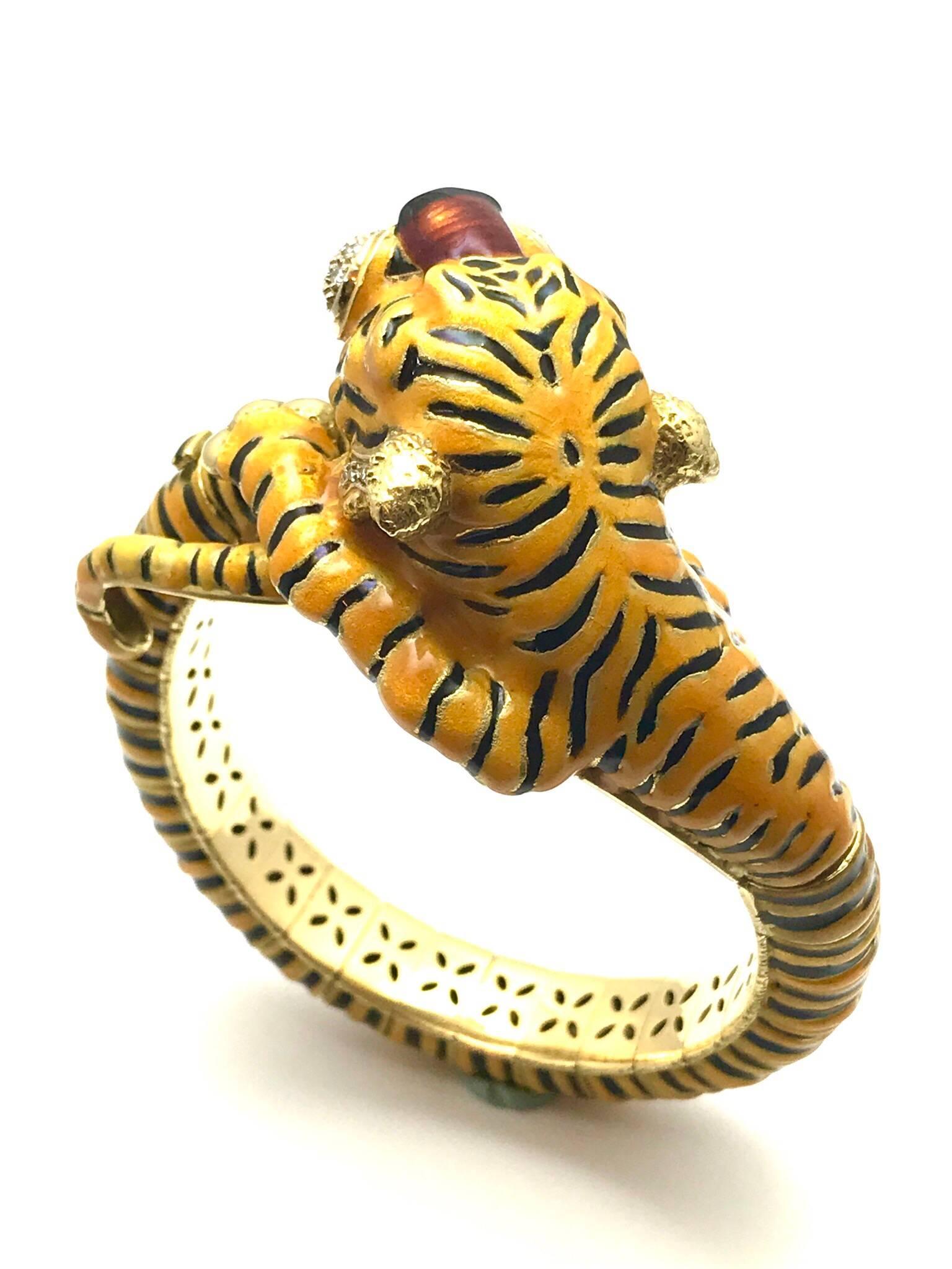 Cartier diamond and enamel 18 karat yellow gold bangle tiger bracelet.  The tiger's mouth and jowls are adorned with 34 single cut round diamonds weighing approximately 0.45 carats.  The bracelet is all 18 kt., applied with yellow/orange enamel and