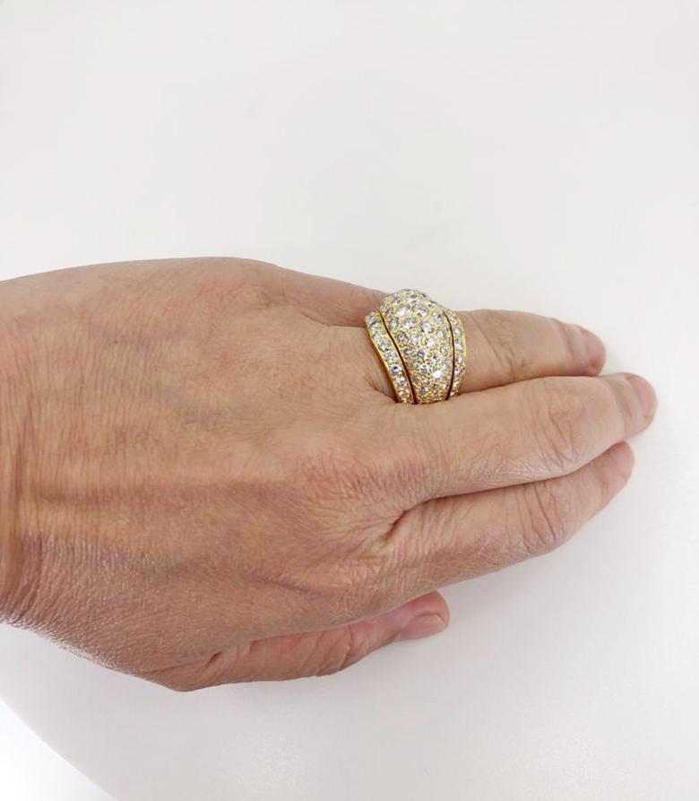 CARTIER Nigeria Diamond Bombe Ring in 18k Yellow Gold.

A tiered ring by Cartier of bombé design covered in white diamond pavé, framed by two rows of round brilliants. The sides continue the fluted look which is sculpted within the yellow gold about