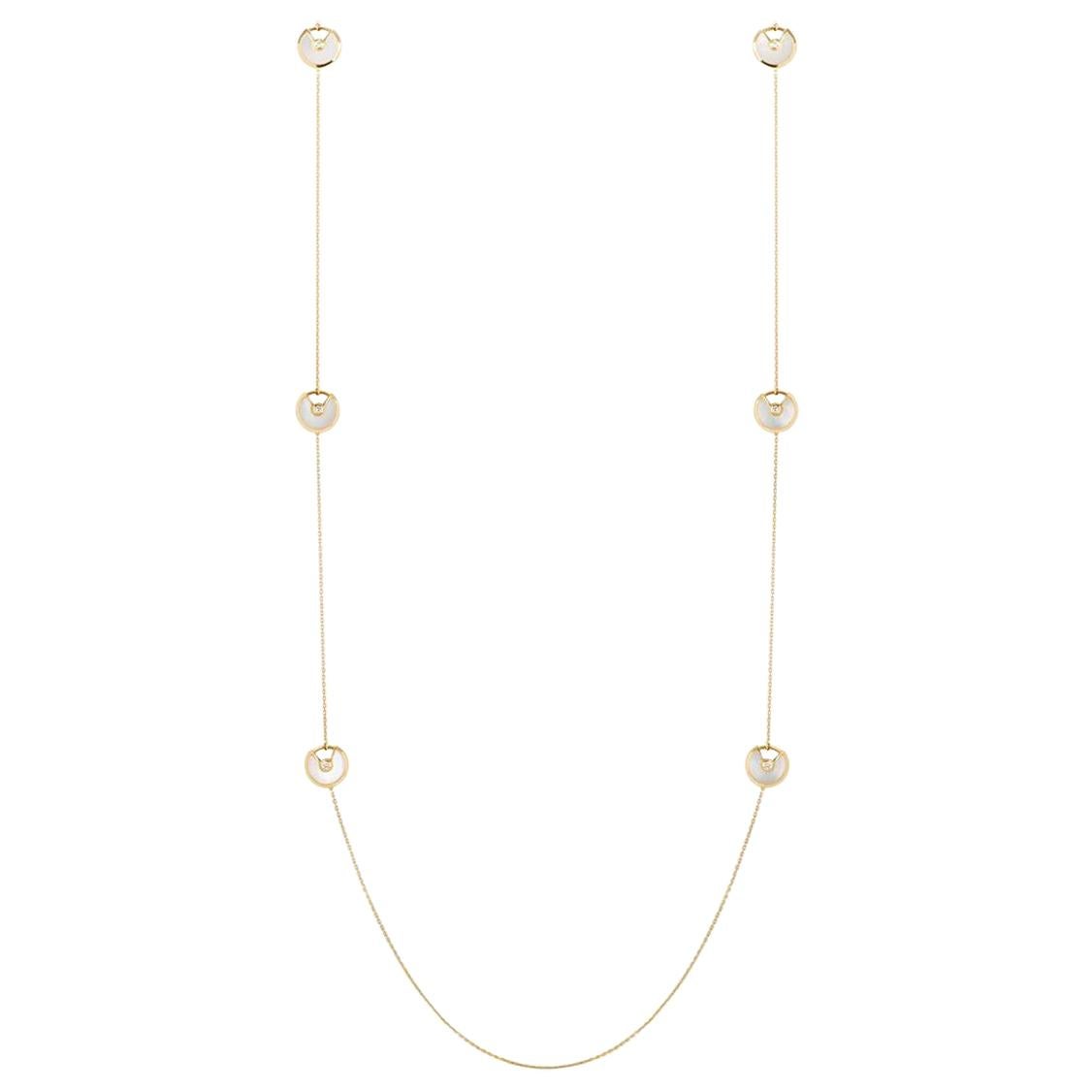 A beautiful 18k yellow gold necklace from the Amulette de Cartier collection. The necklace has 6 circular talisman motifs, each with a mother of pearl inlay and a single round brilliant cut diamond set to the centre. The necklace measures