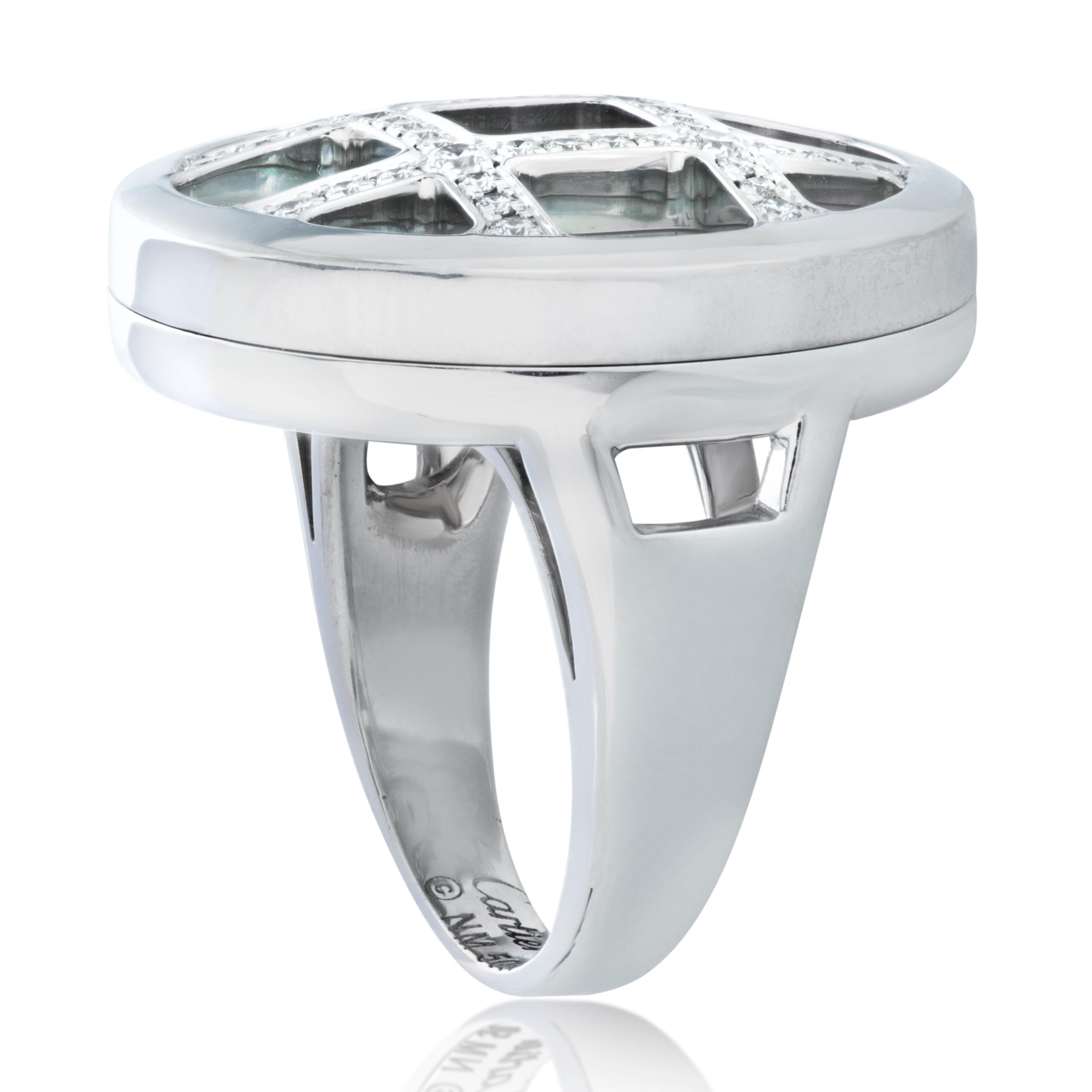 Cartier diamond and mother of pearl Pasha ring in 18k white gold.

This ring features 44 round brilliant cut diamonds with F-G color and VS clarity set in a lattice pattern over mother of pearl.  

The top of the ring measures 24mm in