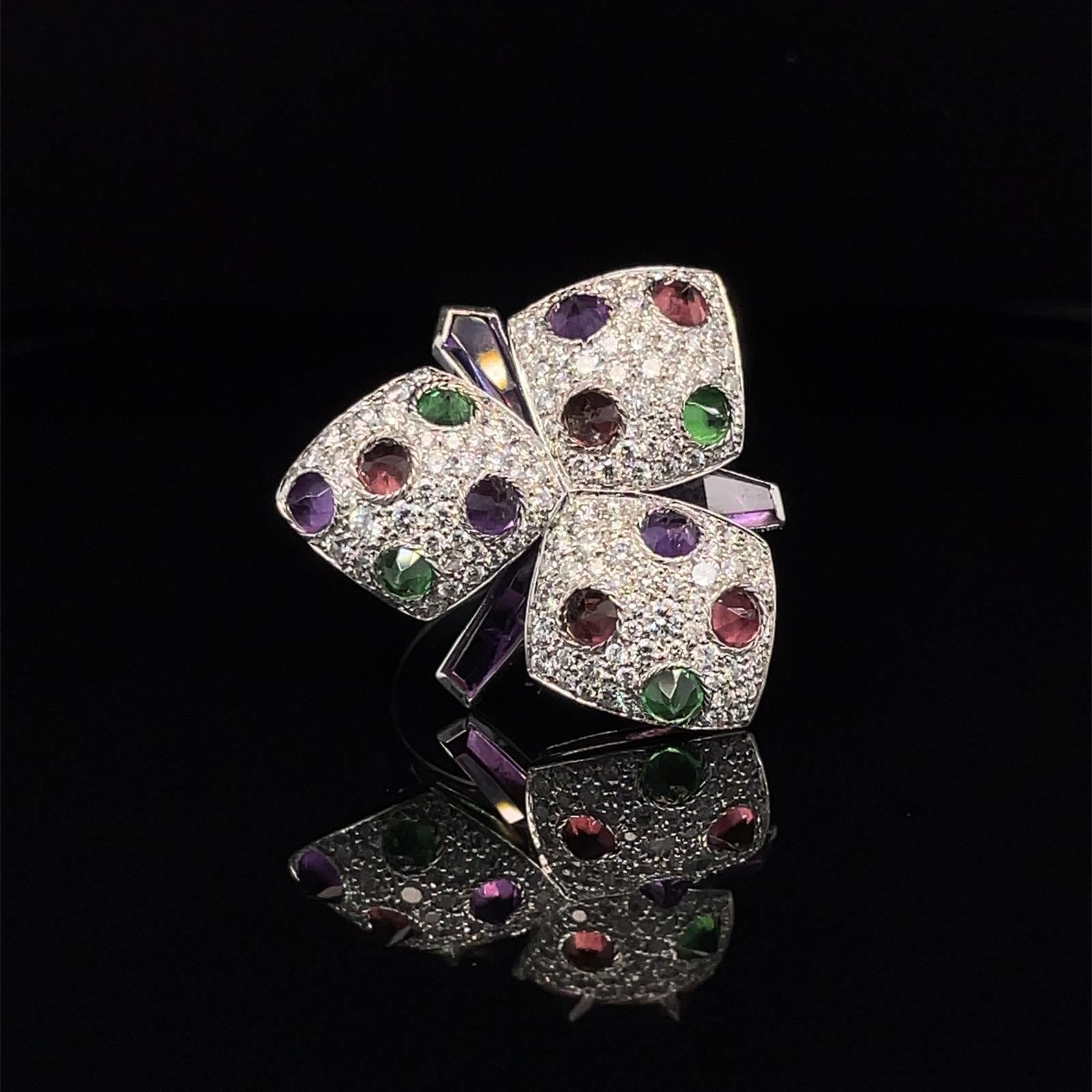 A stunning dress ring from Cartier's Caresse d'Orchidées collection. The ring features pavé of approximately 1.20 ct in total of sparkling diamonds and reverse-set amethysts, pink tourmalines and tsavorites for a total of approximately 1.50