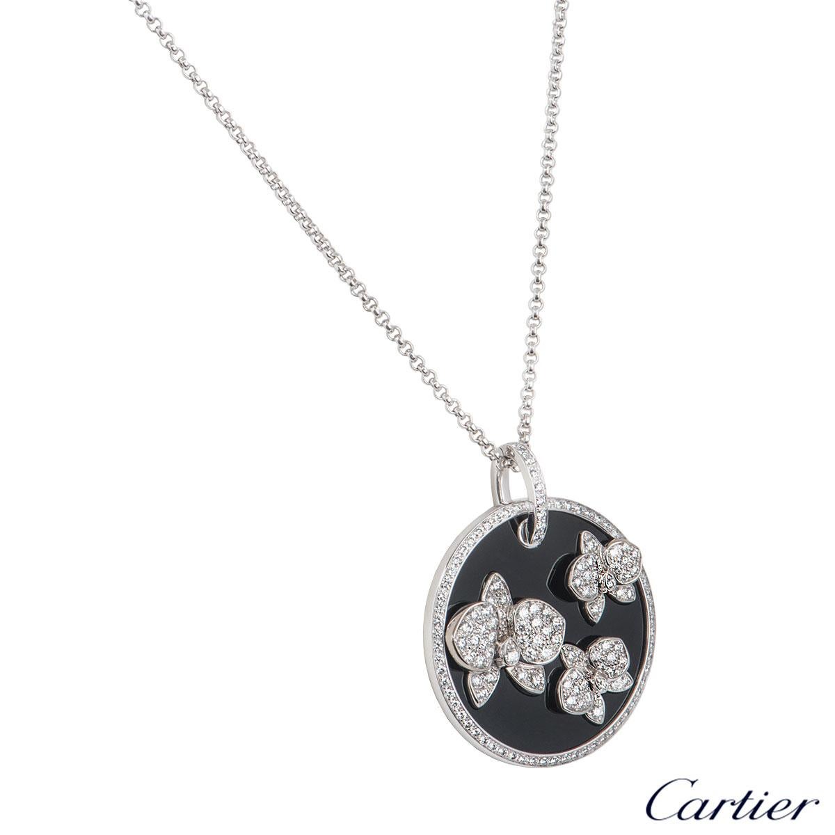 A beautiful 18k white gold diamond and onyx pendant by Cartier from the Caresse D'Orchidees collection. The pendant comprises of a circular onyx motif with 3 orchid motifs pave set with round brilliant cut diamonds. The pendant has 146 round