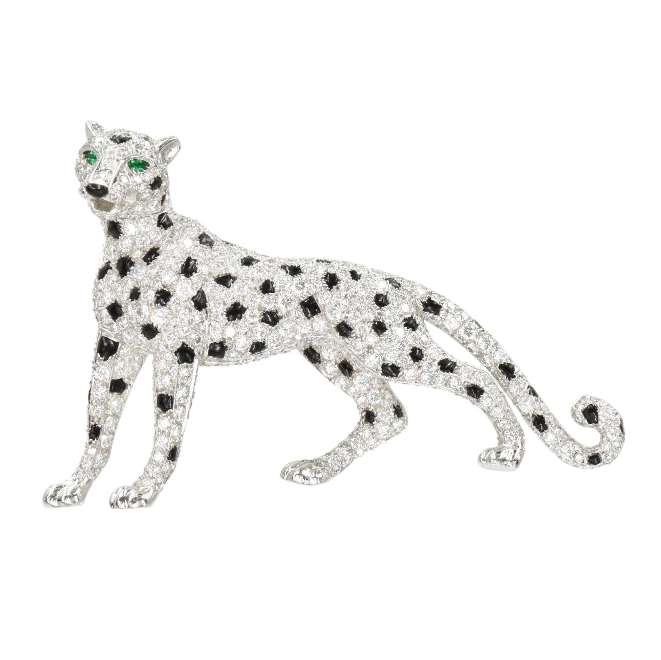 Iconic Cartier Diamond and Onyx Panther Brooch crafted in platinum.
This brooch is designed as a panthere with partially rotating head. Its body encrusted with round brilliant cut diamonds and cabochon cut onyx, accented by pear shape emerald eyes.