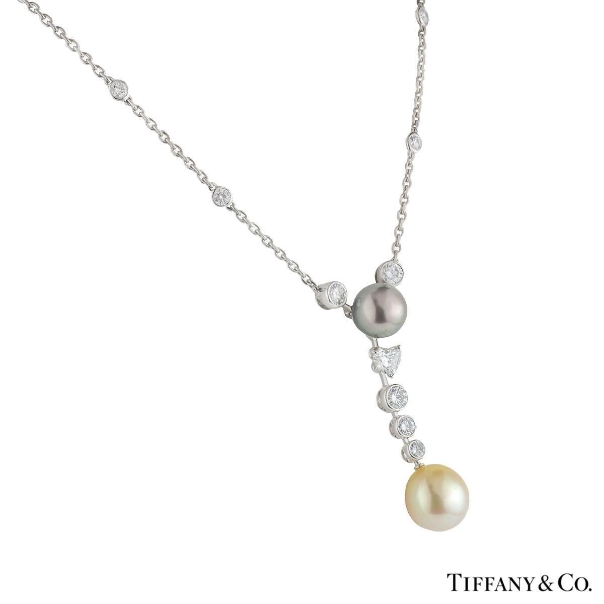 A luxurious platinum Cartier diamond and pearl necklace from the Calin collection. The necklace comprises of a tahitian pearl set to the centre with a heart cut and 3 round brilliant cut diamonds graduating in a vertical drop, finished of with a