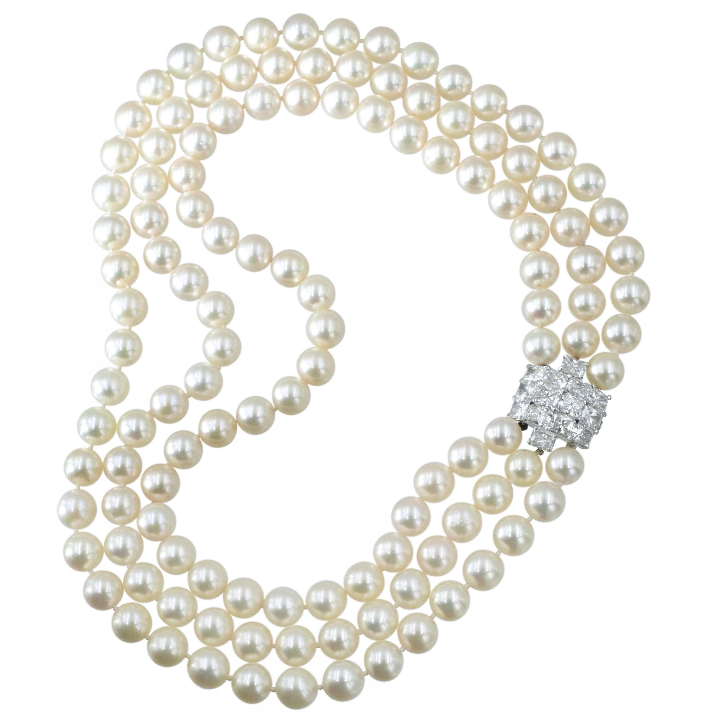 Cartier Triple Strand Cultured Pearl Necklace with Platinum and Diamond Clasp. Composed of three strands of pearls ap. 10.0 to 9.3 mm., completed by a clasp of 14 cut-cornered rectangular modified brilliant diamonds weighing total of approximately