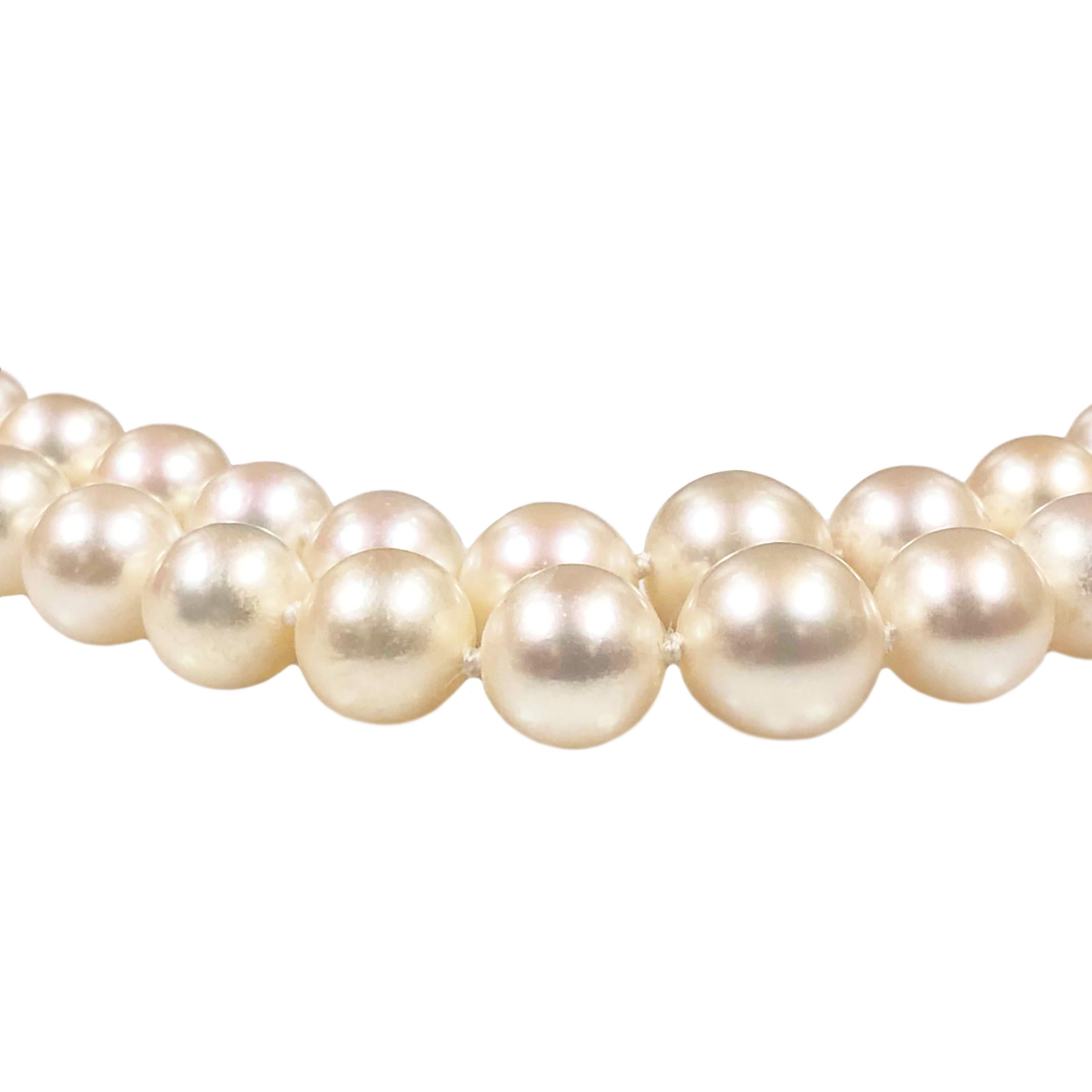 Circa 1960s Cartier Double Strand necklace measuring 16 1/2 inches in length and comprised of Fine Round Cultured Pearls measuring in size from 7.5 MM up to 10 MM, the Pearls are White in Color with a light Pink tint, they Grade as A+ with very