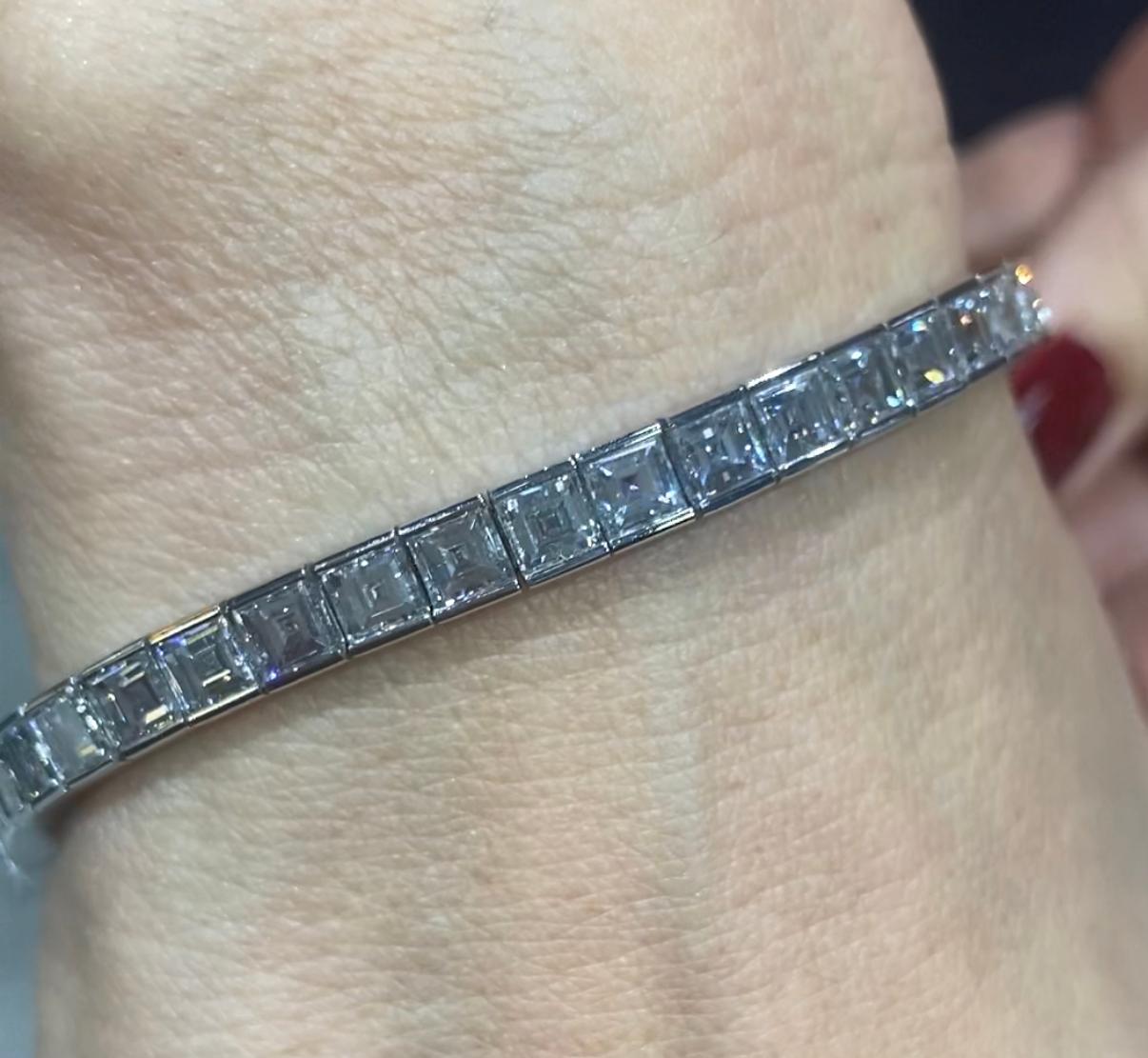 A stunning tennis bracelet with 39 princess cut diamonds totalling approximately 14 carats made by Cartier circa 1940s.

The bracelet comes with a certificate stating that the diamonds are F to H colour and VVS1 to VS1 in clarity.

It is beautiful