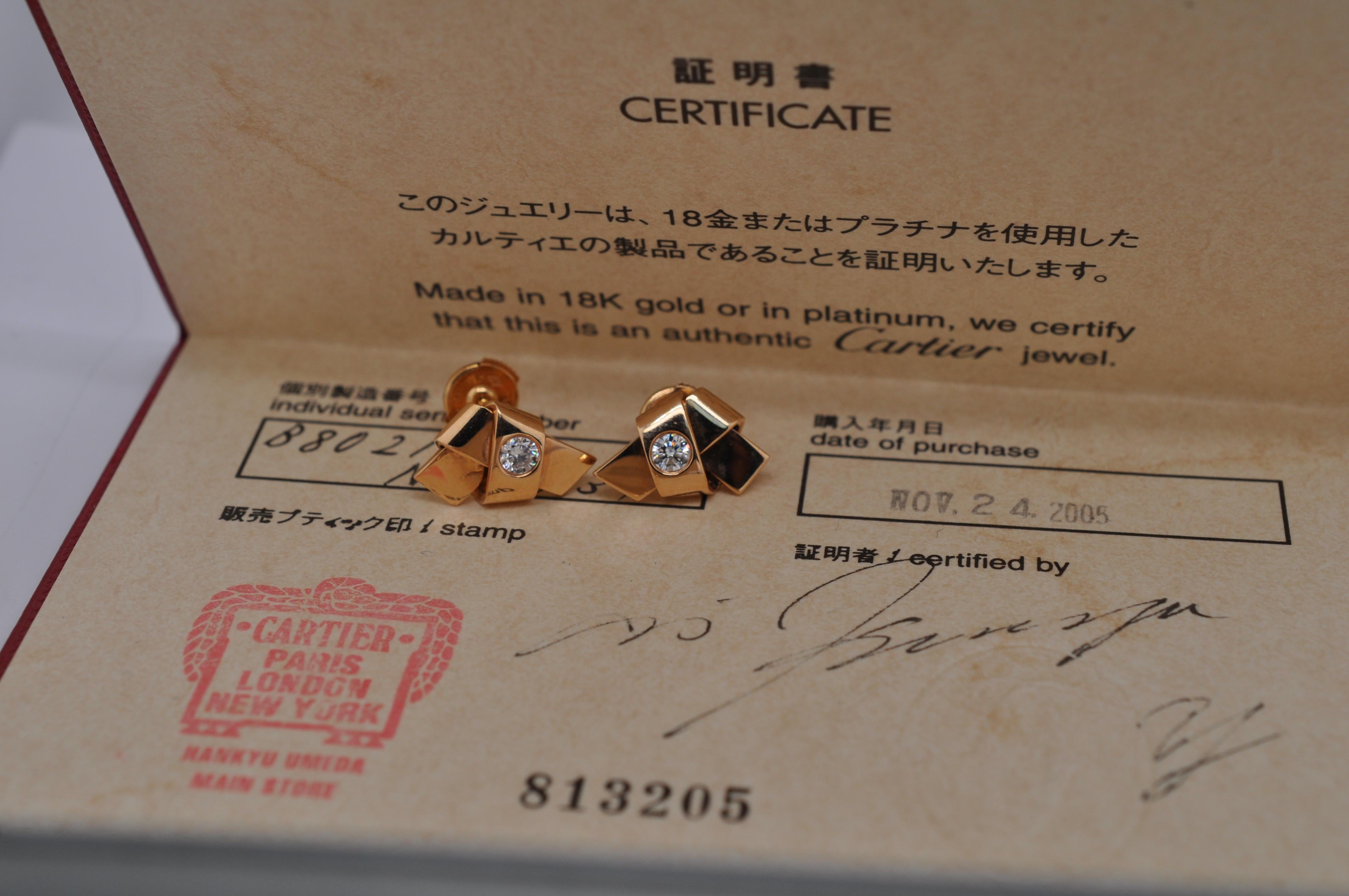 Brand: Cartier

Stones: Diamond 

Metal: Rose Gold

Style: Ribbon Knot Stud Earrings

Hallmarked: Cartier 750

Papers: Yes

Year: 2005

Condition: Very Good