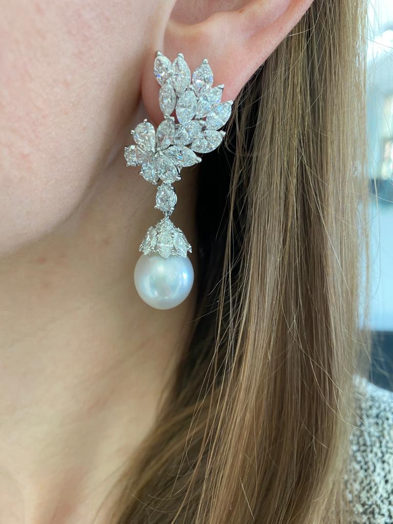Cartier Diamond and South Sea Cultured Pearl Pendant-Earclip Earrings in Platinum with detachable pendants. The earrings consist of diamond set clusters and caps, set with 38 marquise and 10 pear- shaped fine quality diamonds weighing total of