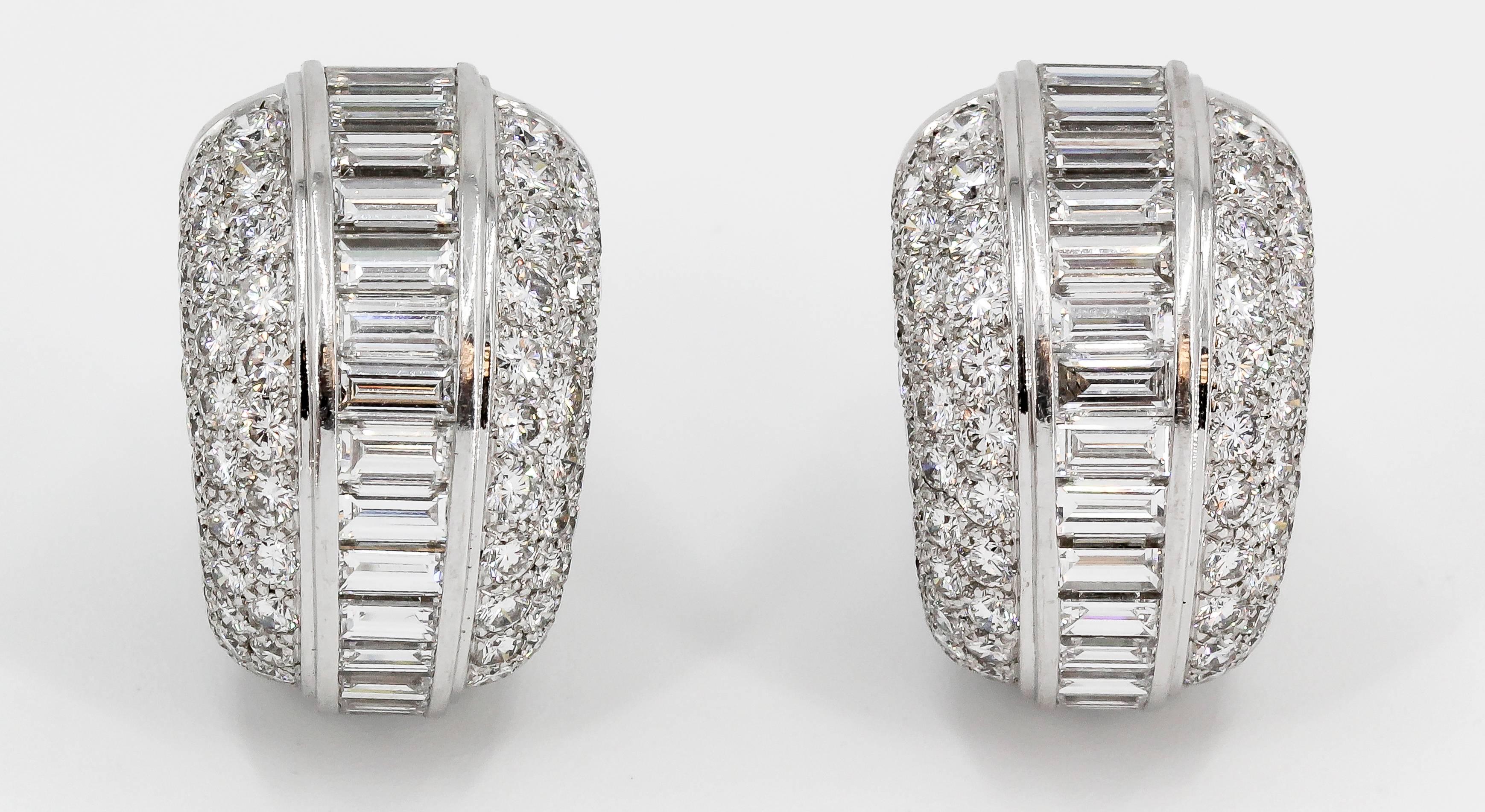 Very fine diamond and 18K white gold hoop earrings by Cartier. They feature high grade round and tapered baguette cut diamonds of F-G color and VVs clarity, approx. 10 carats total weight. A stunning pair of earrings that are exceptionally crafted. 