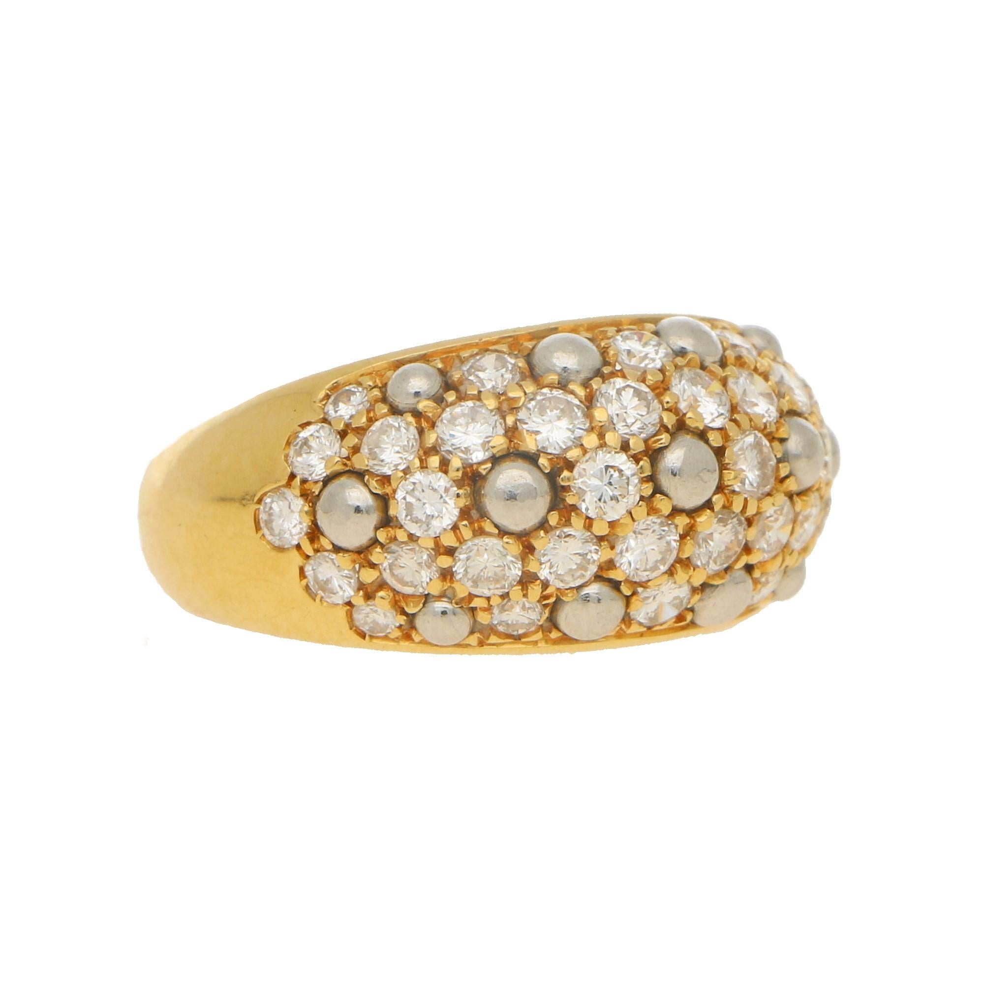 A stunning contemporary diamond bombe cocktail dress ring set in 18k yellow and platinum, signed Cartier. The piece is beautifully interspersed with small platinum beads, these break up the diamonds that are pavé set within the ring and add to the