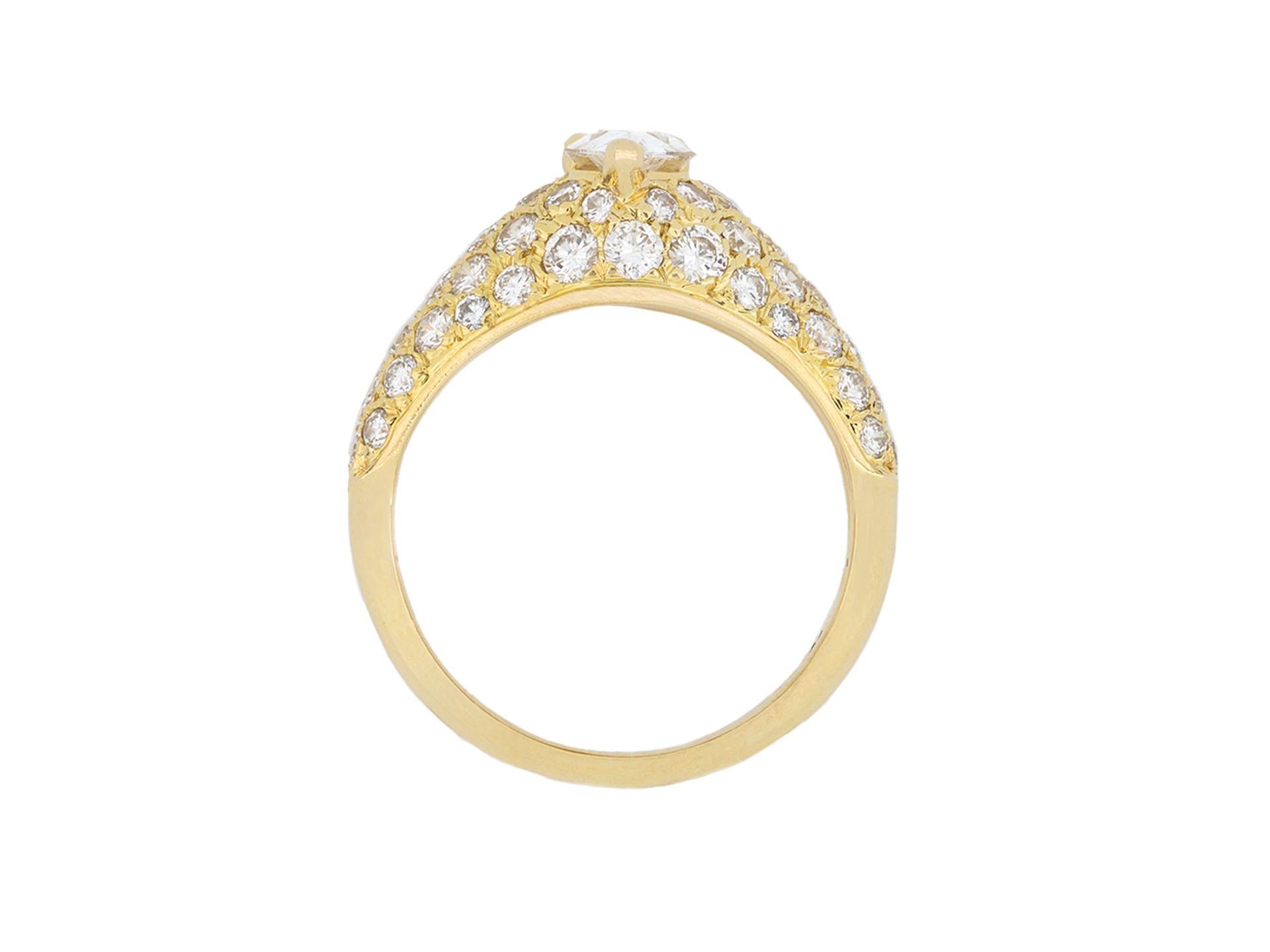 Cartier diamond bombe ring. Centered with a drop shape brilliant cut diamond in an open back claw setting with an approximate weight of 0.50 carats, raised above fifty two round brilliant cut diamonds in an open back grain settings with a combined