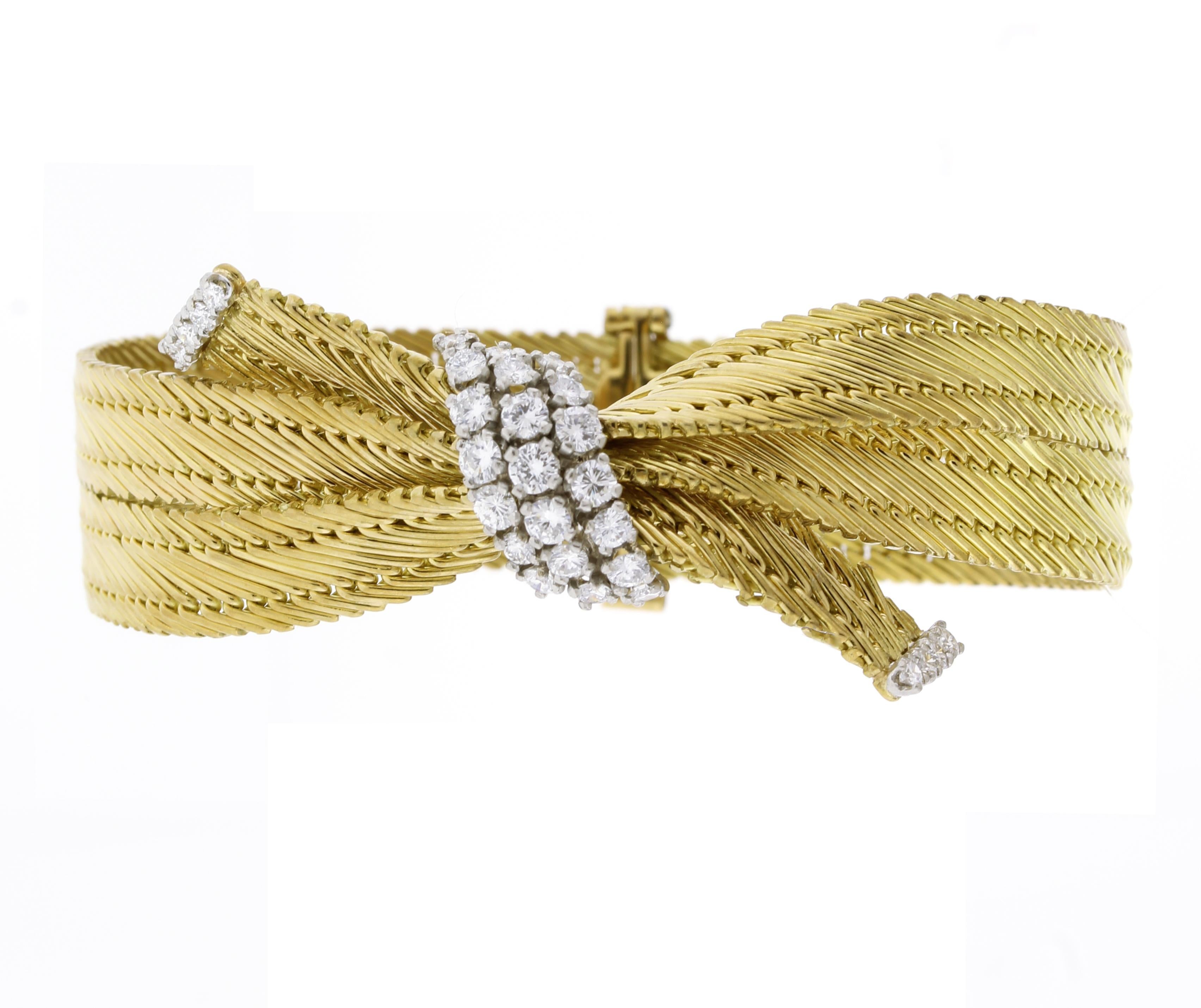 From Cartier, a mid century diamond bow bracelet
♦ Designer: Cartier
♦ Metal: 18 karat
♦ Circa 1960s
♦ 6 5/8t of an long
♦ 5/8ths wide 
♦ 29 Diamonds=1.45 carats
♦ Packaging: Cartier box
♦ Condition: Excellent , pre-owned
♦ Price: Based on the