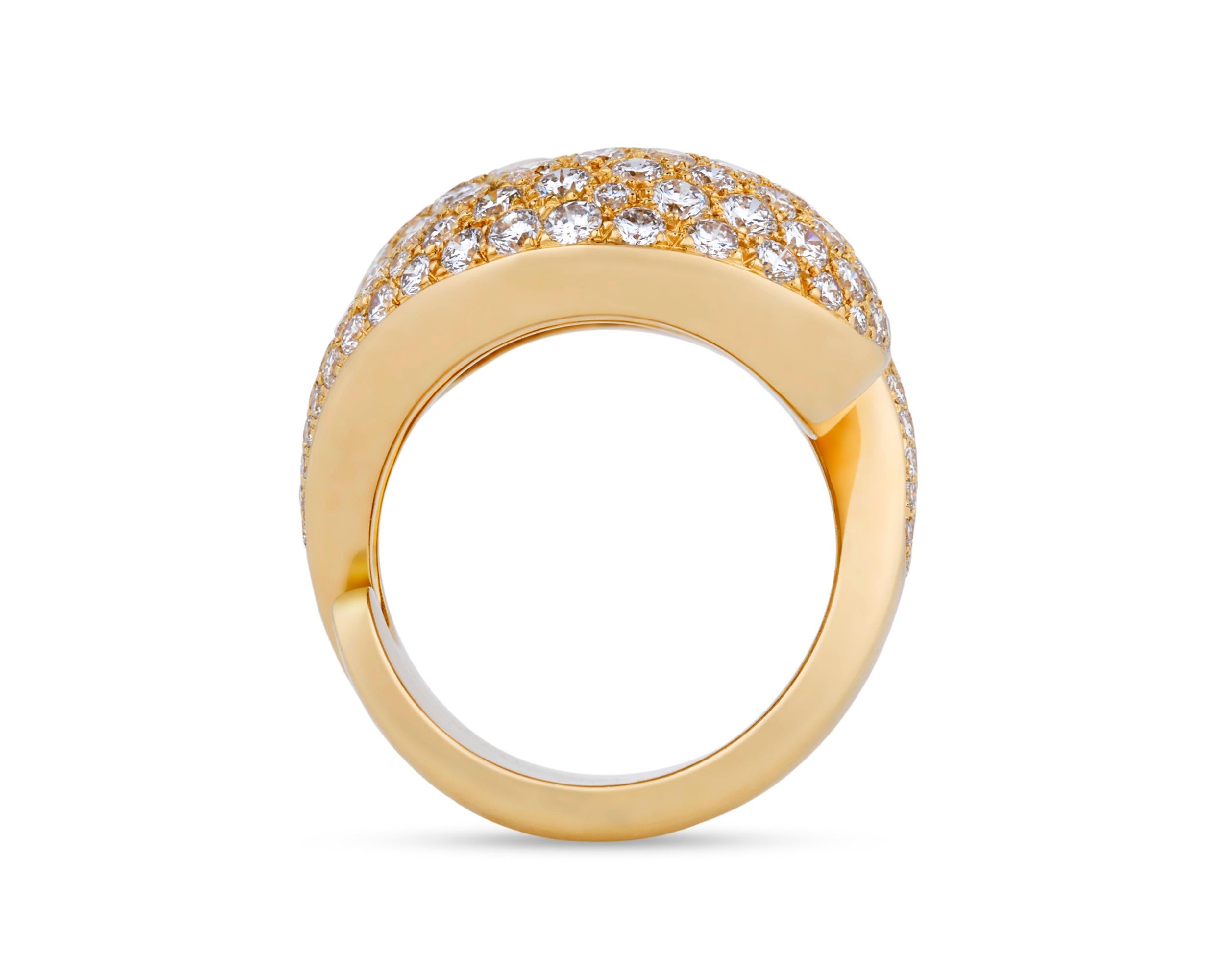 An incredible contemporary design by the legendary Cartier sets apart this exceptional bypass ring. Crafted of 18k yellow gold, the piece is designed as two curved, bombe sections in symmetrical opposition, both pavé set with approximately 5.00