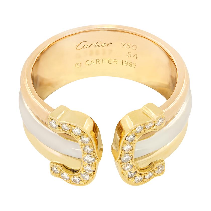 An icon from Cartier’s past, this C De Cartier ring features a bold design made in three types of 18 carat gold, yellow, white and rose. On each ‘C’ there are twenty two diamonds which have been grain set in yellow gold. These diamonds total to 0.25