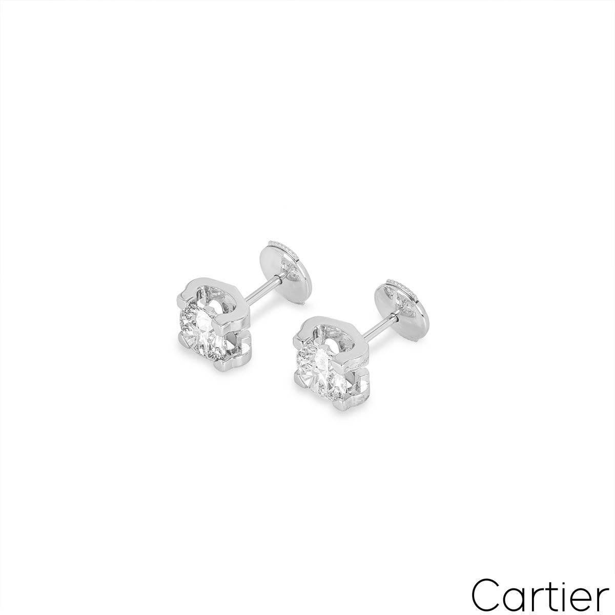 An exquisite pair of white gold diamond earrings by Cartier from the C de Cartier collection. The earrings feature a C design on both sides that securely encase the diamonds to the centre. Each earring is set with a round brilliant cut diamond