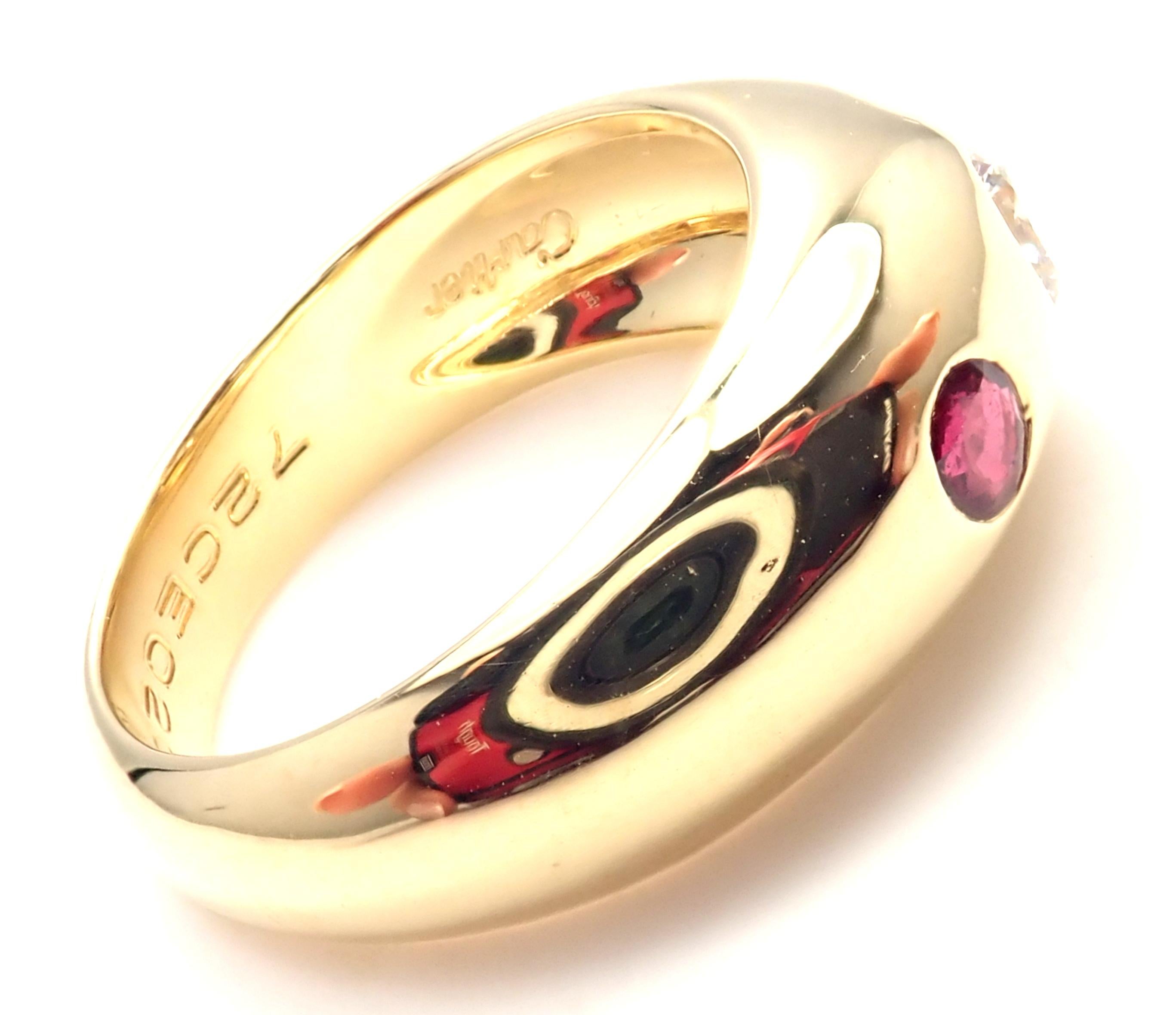 18k Yellow Gold And Diamond Ruby Band Ring by Cartier. 
With 1 diamond approx. .10ctw
VVS1 clarity, H color
2 rubies approx .05ct each
Measurements: 
Weight: 7.8 grams
Width:  8mm
Ring Size: European 51 US 5 3/4
Stamped Hallmarks: 750 Cartier 51