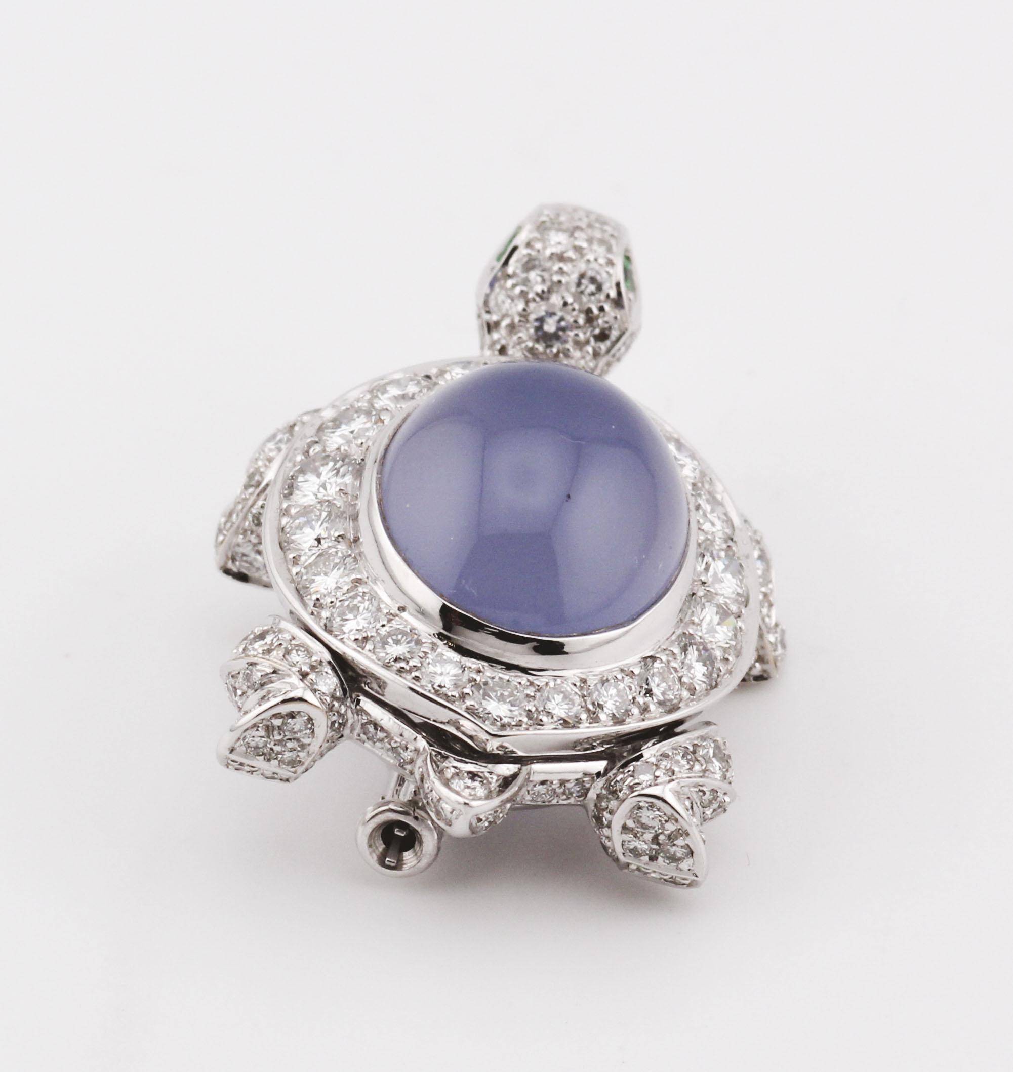 A whimsical yet luxurious creation, this exquisite turtle brooch from Cartier is a masterful blend of fine artistry and precious materials. Crafted in shimmering 18K white gold, the brooch features a meticulously sculpted chalcedony shell in a soft,