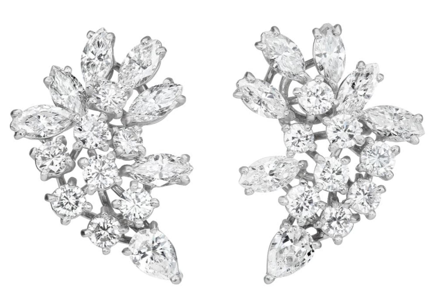 These earrings are a Cartier masterpiece, with each of the 15 diamonds designed varying in shape, featuring marquise, pear and round shapes, making for a beautiful diamond cluster earring, meticulously mounted in 18K white gold. 

Signed 'Cartier'