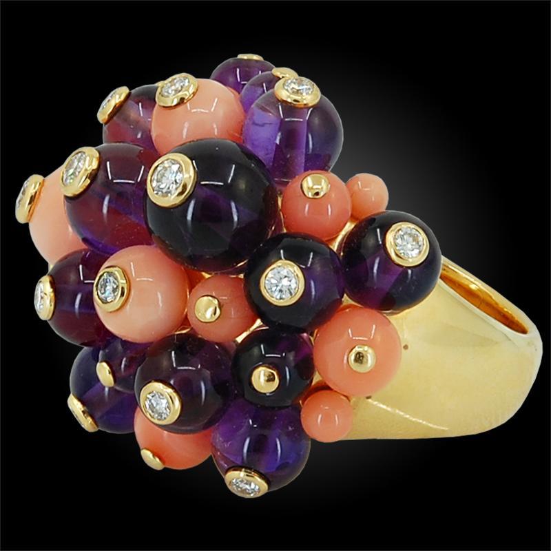 An enchanting ‘Delice de Goa’ ring by Cartier, of bombe design, set with clusters of polished coral and amethyst beads, each accentuated at the center with bezel-set brilliant round diamonds crafted in 18k yellow gold.

RING SIZE- 57
FRENCH ASSAY