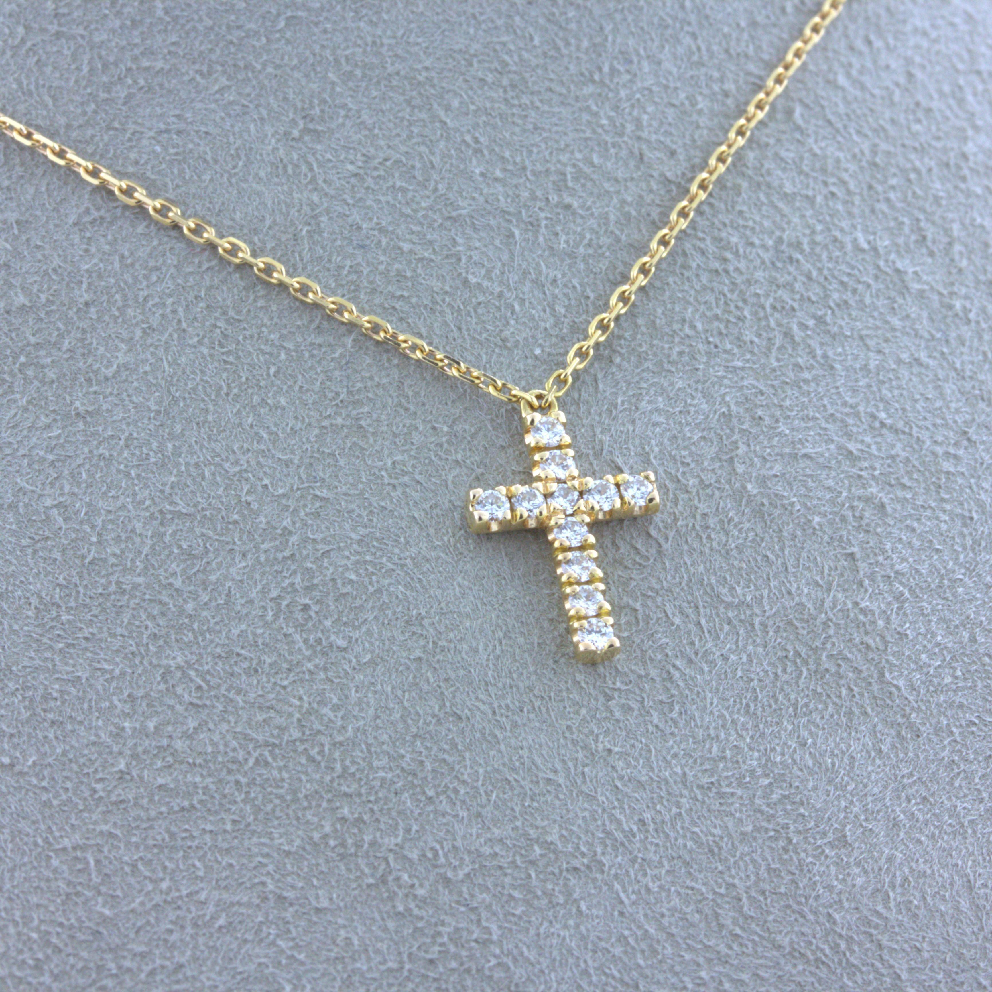 A simple yet fine and elegant cross necklace by Cartier. It features 11 round brilliant-cut diamonds set over the cross which sparkles as it moves in the light. Made in 18k rosy-yellow gold with a cartier double-C charm on the lobster clasp. A