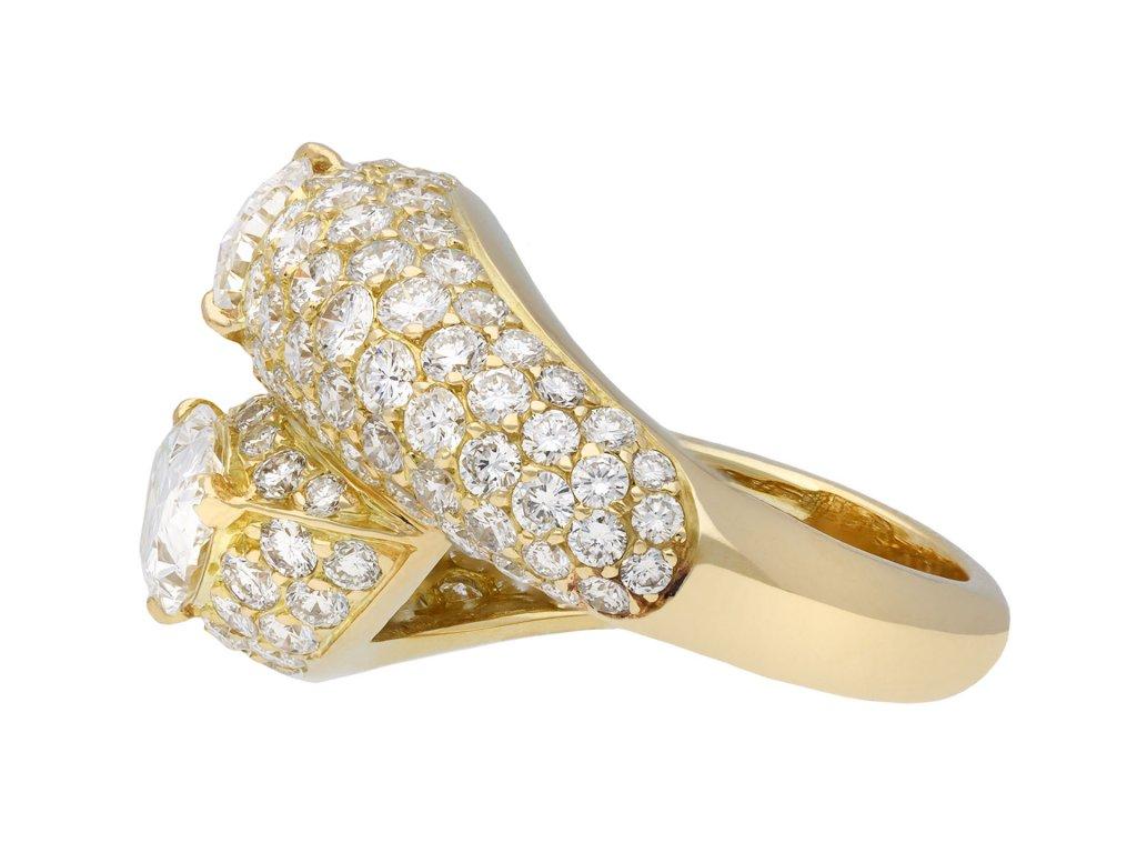 Cartier diamond crossover ring. Set with two drop shape brilliant cut diamonds, one D colour, VVS2 clarity, with a weight of 1.17 carats, the other D colour, VVS1 clarity, with a weight of 1.19 carats in open back claw settings with a combined