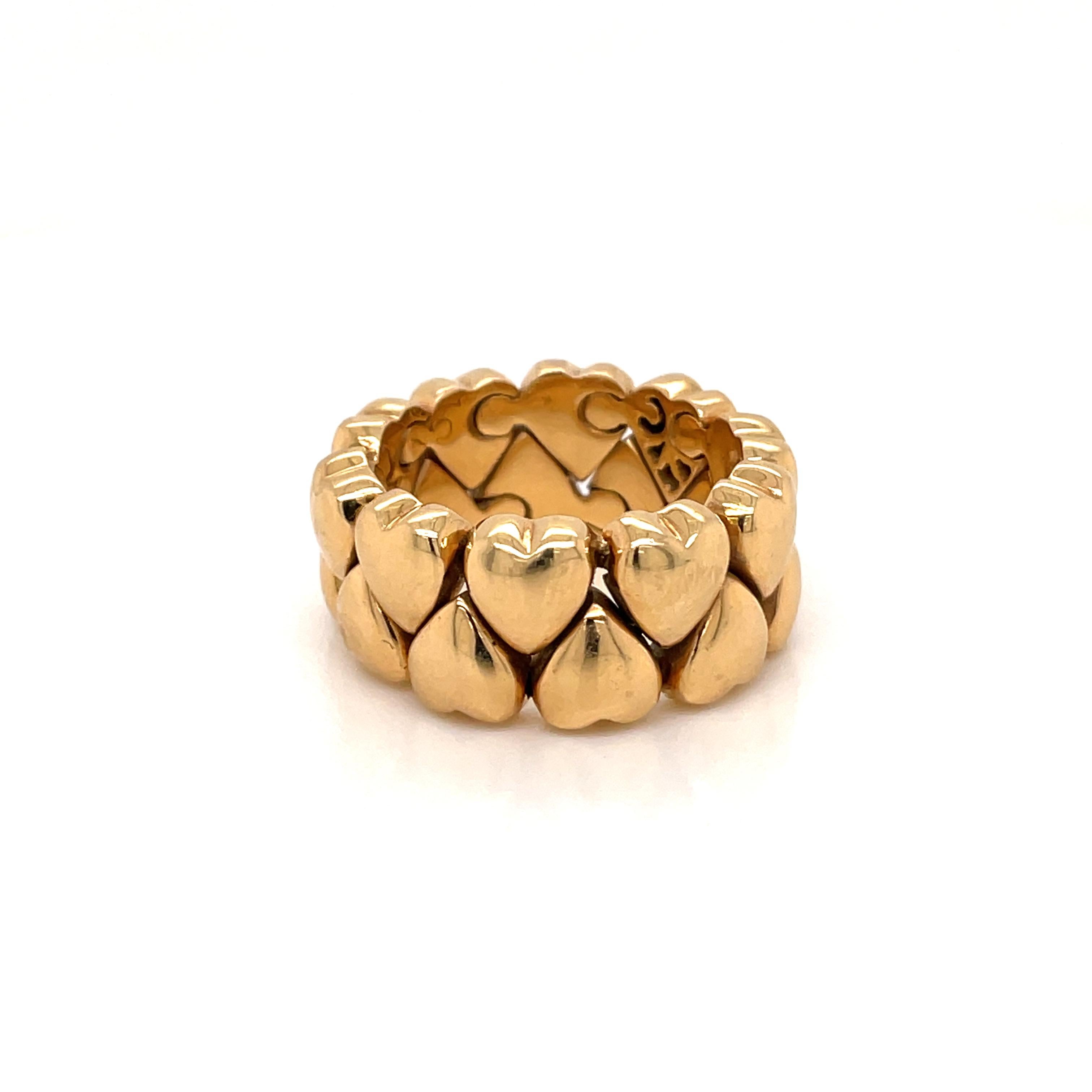 Iconic Cartier Ring from Double Coeurs collection
Flexible band ring comprised of two rows of polished gold hearts, it features one fully diamond pave heart, approx. 0.15 carats F color IF

Marked: fully signed Cartier, 1995, numbered, 750. Weight -