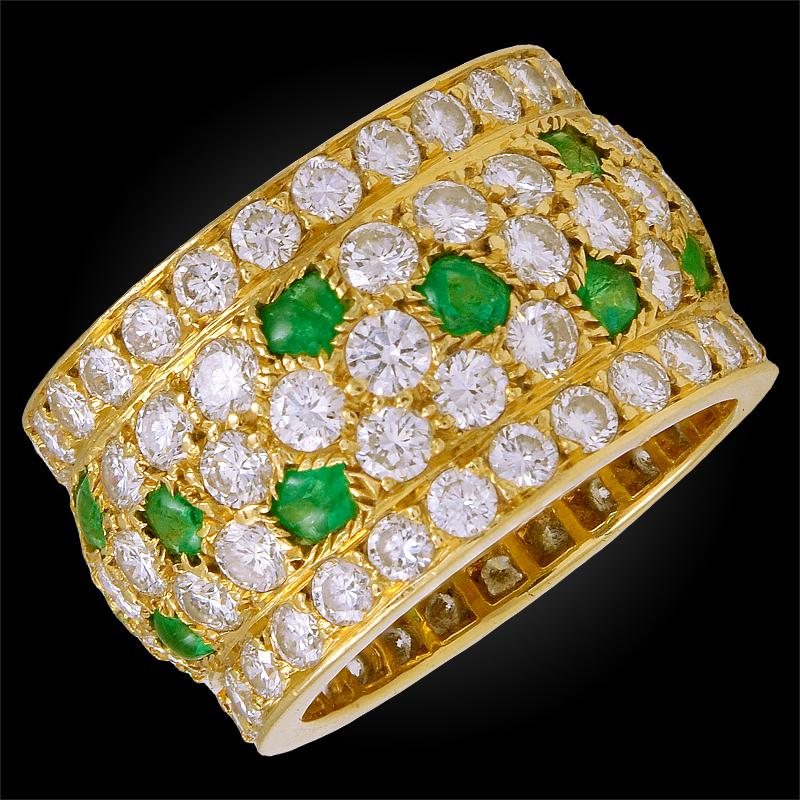 A Cartier Nigeria band crafted with a myriad of diamonds and emeralds mounted in an 18k yellow gold design, signed Cartier.
Ring size 51