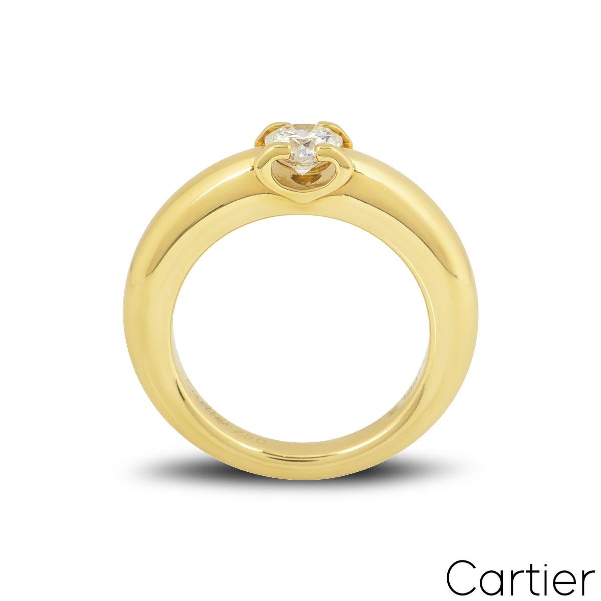 A classic 18k white gold diamond ring by Cartier from the C De Cartier collection. The ring is set to the centre in a four claw mount with a round brilliant cut diamond weighing 0.40ct, G colour and VS1 clarity. The ring measures 4mm wide, is