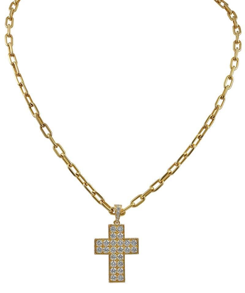 A Cartier pendant necklace, designed as an 18k gold chain suspending a simple cross set with 22 brilliant-cut round diamonds.
Measuring approximately 19 1/2 inches long.

Signed Cartier, with French assay marks.