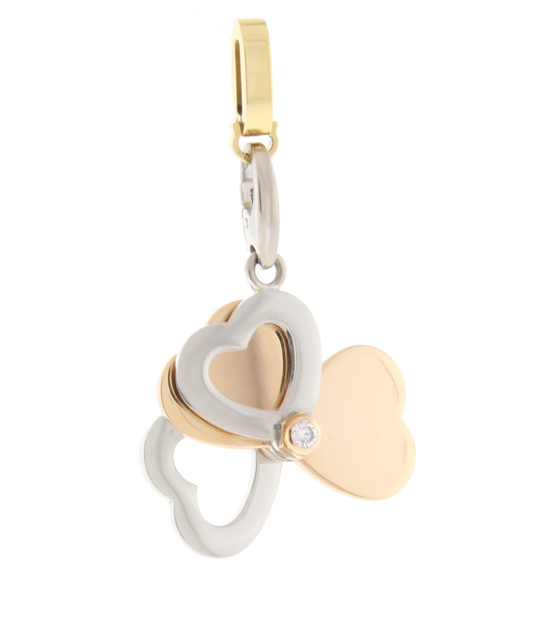 From Cartier thier iconic 18 karat pink, white and yellow gold heart clover charm. The hearts open to form a four leaf clover. Can be worn as a charm or pendant
♦ Designer: Cariter
♦ Metal: 18 karat
♦ 2 Diamonds=.12 carats
♦  1 inch when opened
♦
