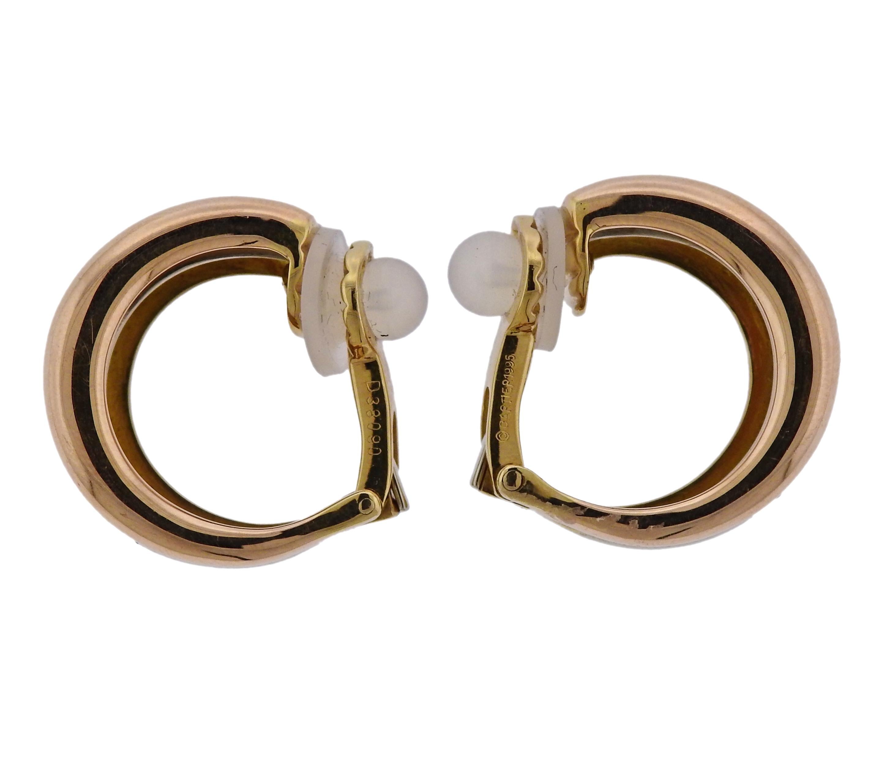 18k gold hoop earrings, designed by Cartier, set with approx. 0.28ctw in G/VS diamonds. Earrings are 22mm in diameter x 9mm wide, weigh 23.4 grams. Marked: D38090, Cartier, 1995, 750.