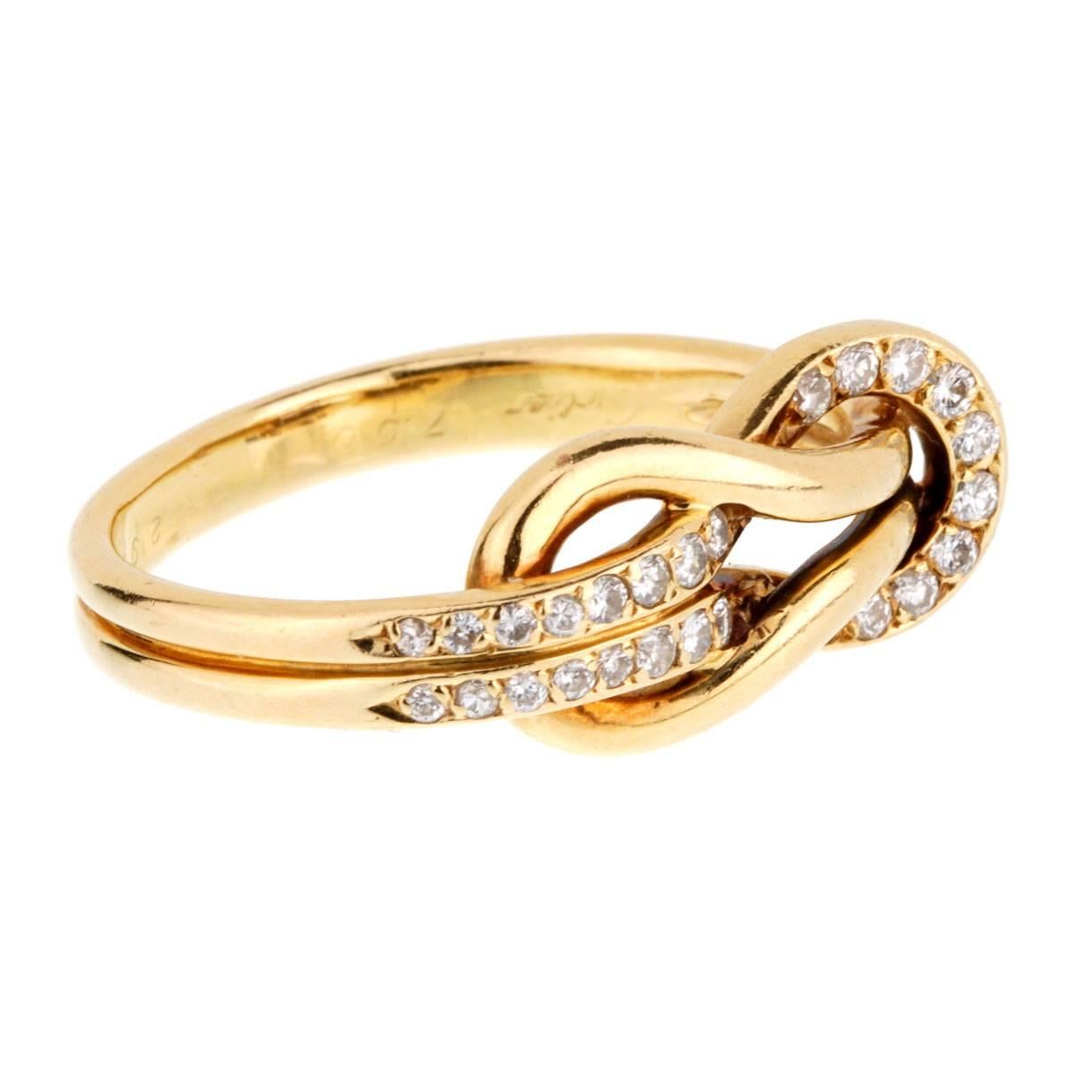 A rare Cartier love knot ring featuring round brilliant cut diamonds set in 18k yellow gold.

Size 6